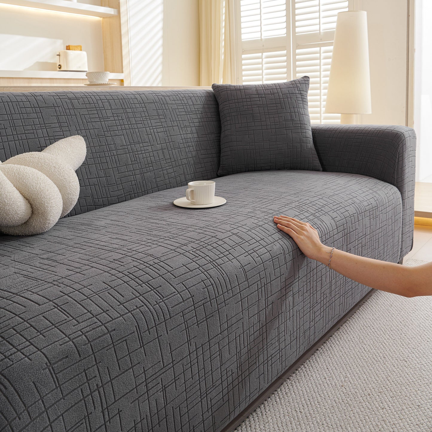 Embossed Lines Couch Covers Stretchable Non-Slip & Washable Sofa Slipcovers on a gray sofa with a stylish texture.
