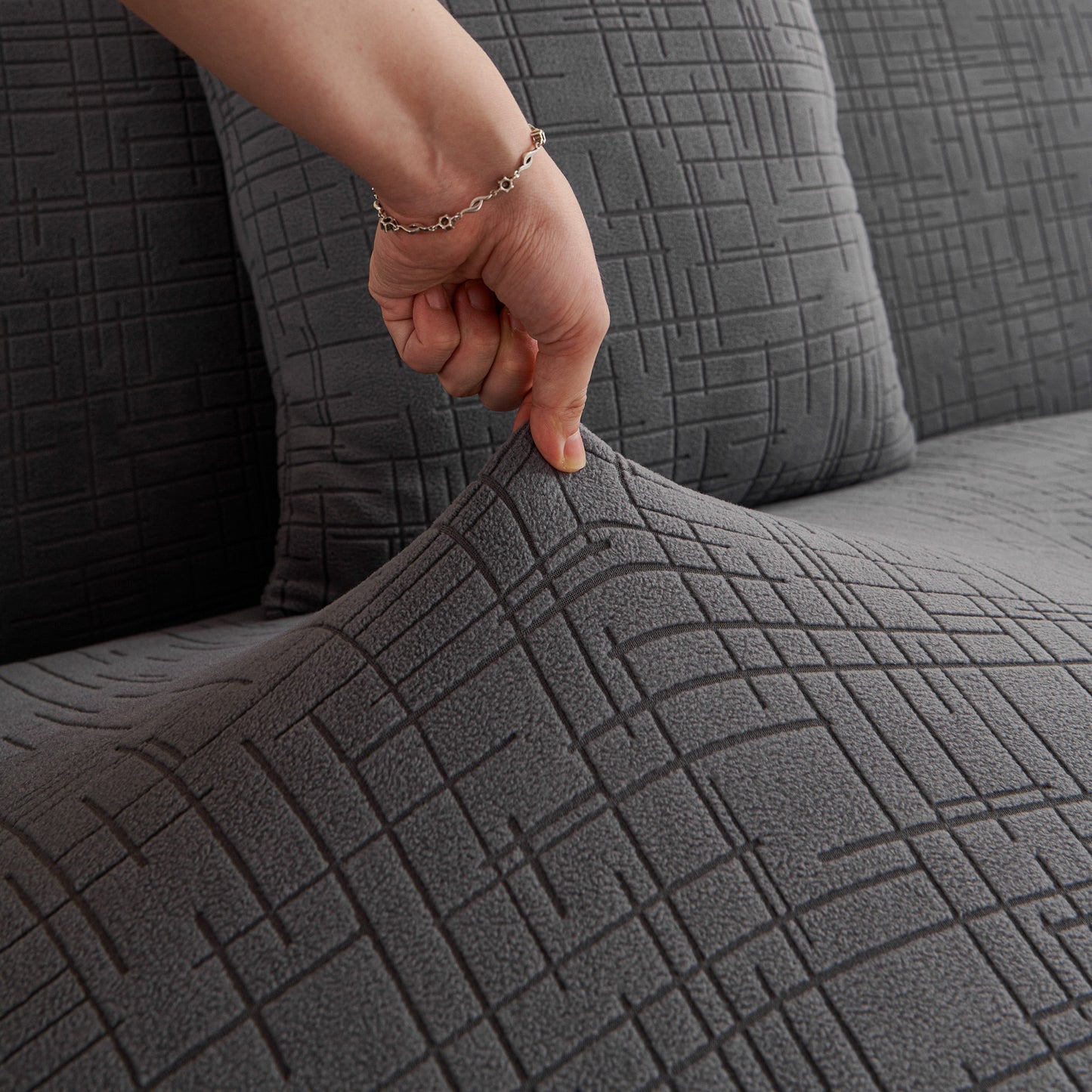 Embossed Lines Couch Covers Stretchable Non-Slip & Washable Sofa Slipcovers being stretched over a couch