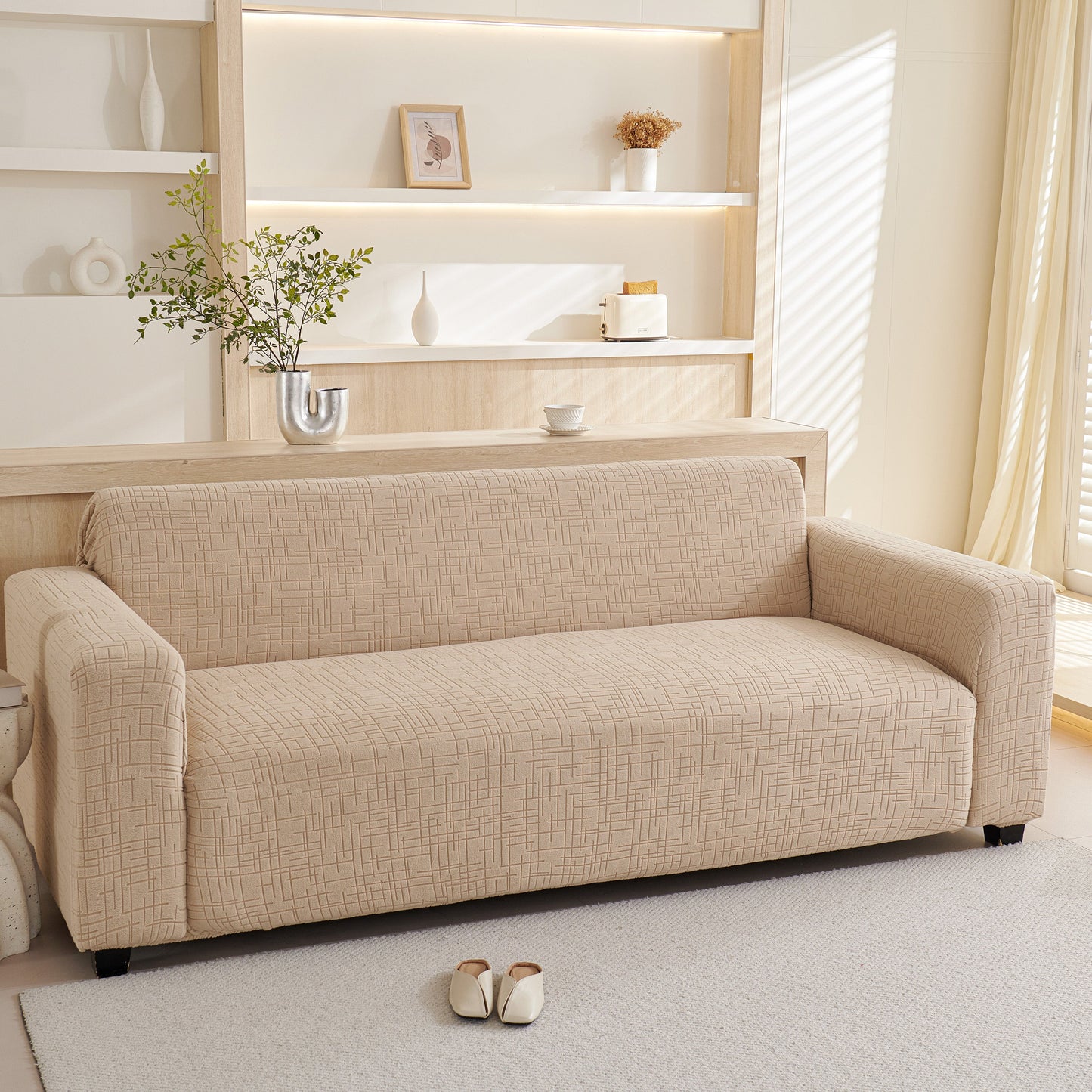 Embossed Lines Couch Covers Stretchable Non-Slip & Washable Sofa Slipcovers on a beige couch in a bright living room.