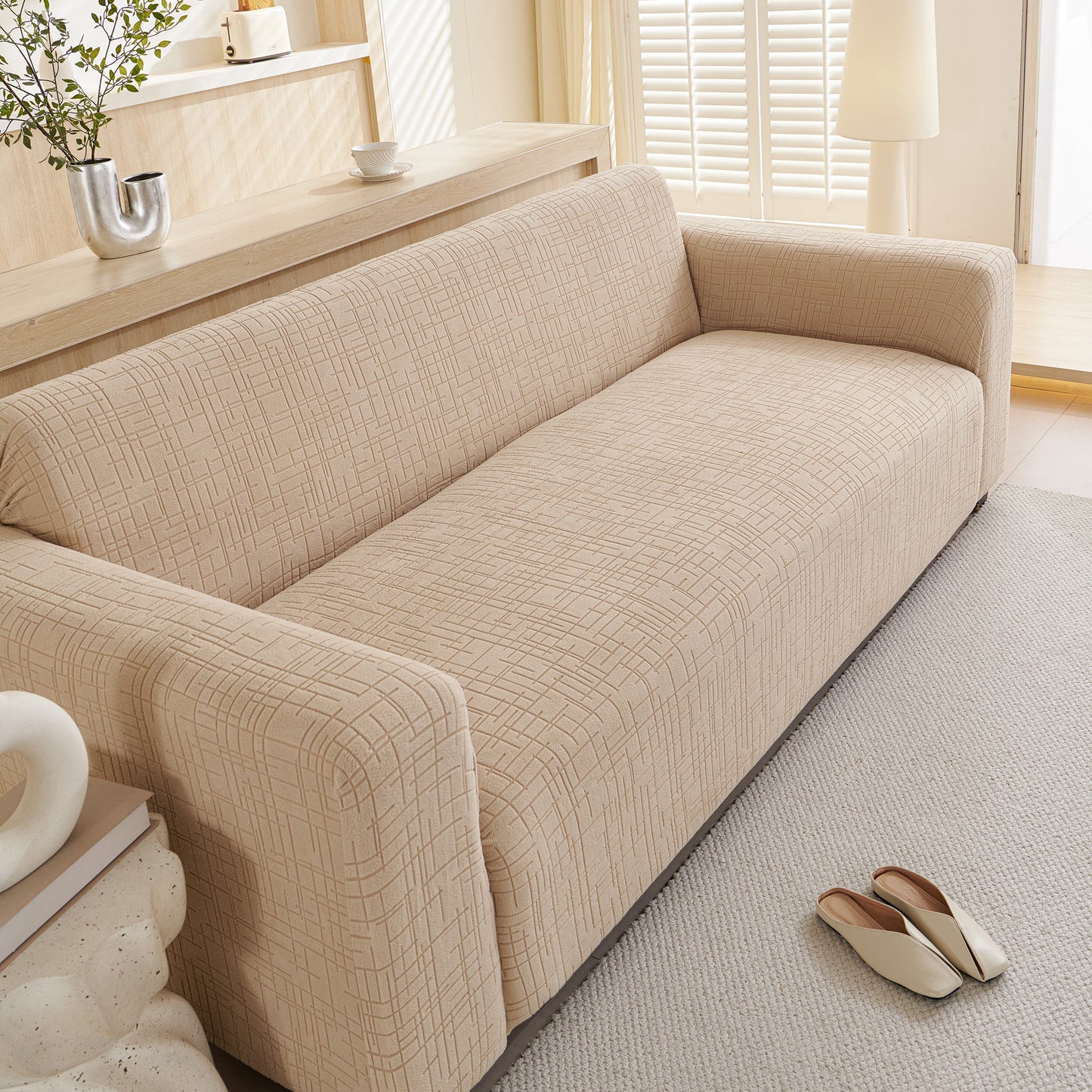 Embossed Lines Couch Covers Stretchable Non-Slip & Washable Sofa Slipcovers on a beige sofa for dust and spill protection.