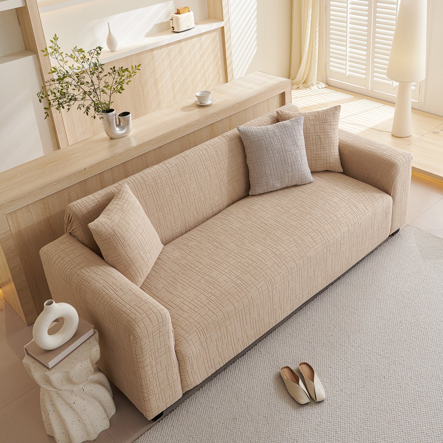 Embossed Lines Couch Covers Stretchable Non-Slip & Washable Sofa Slipcovers on a beige couch in a bright living room