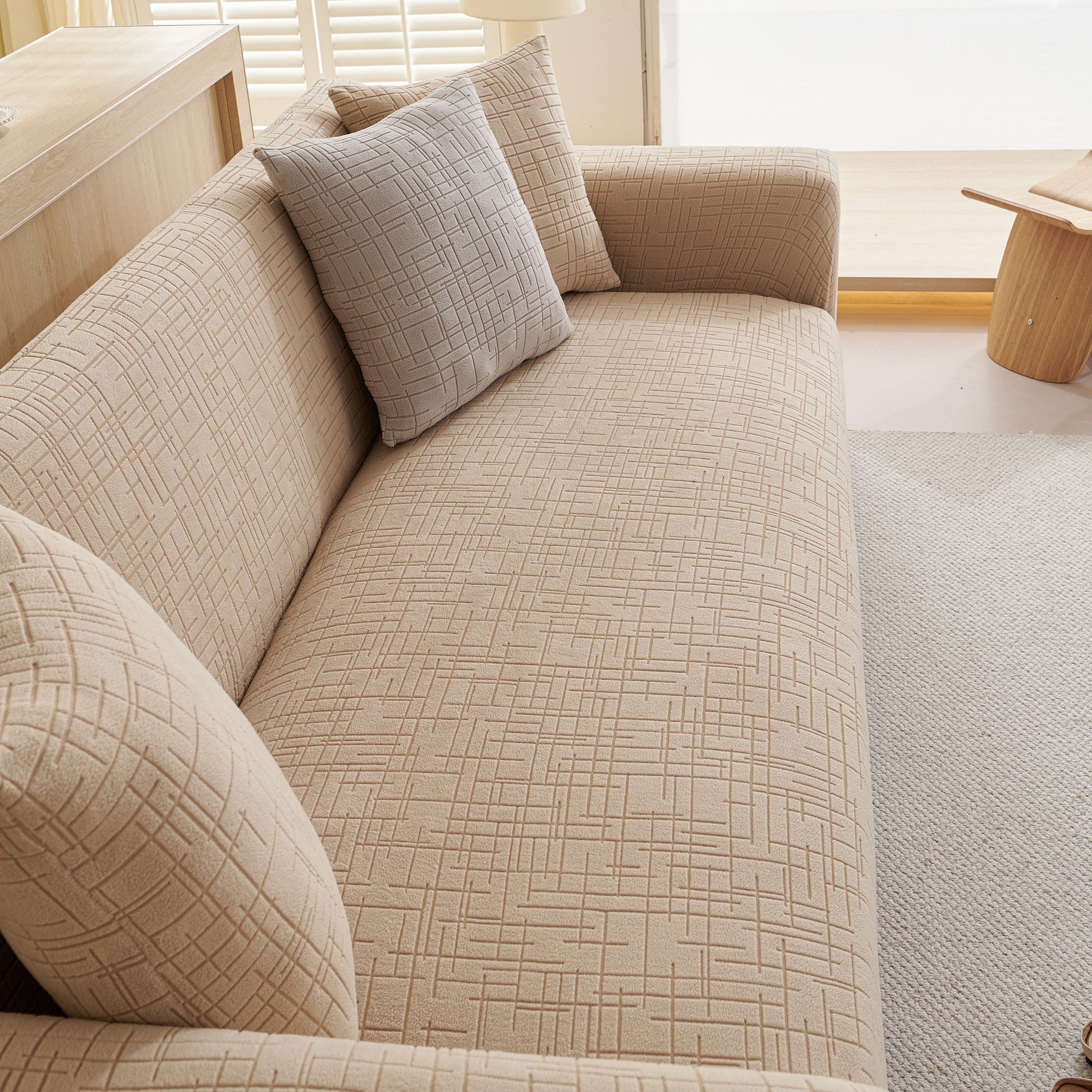 Embossed Lines Couch Covers Stretchable Non-Slip & Washable Sofa Slipcovers on beige sofa with geometric pattern.