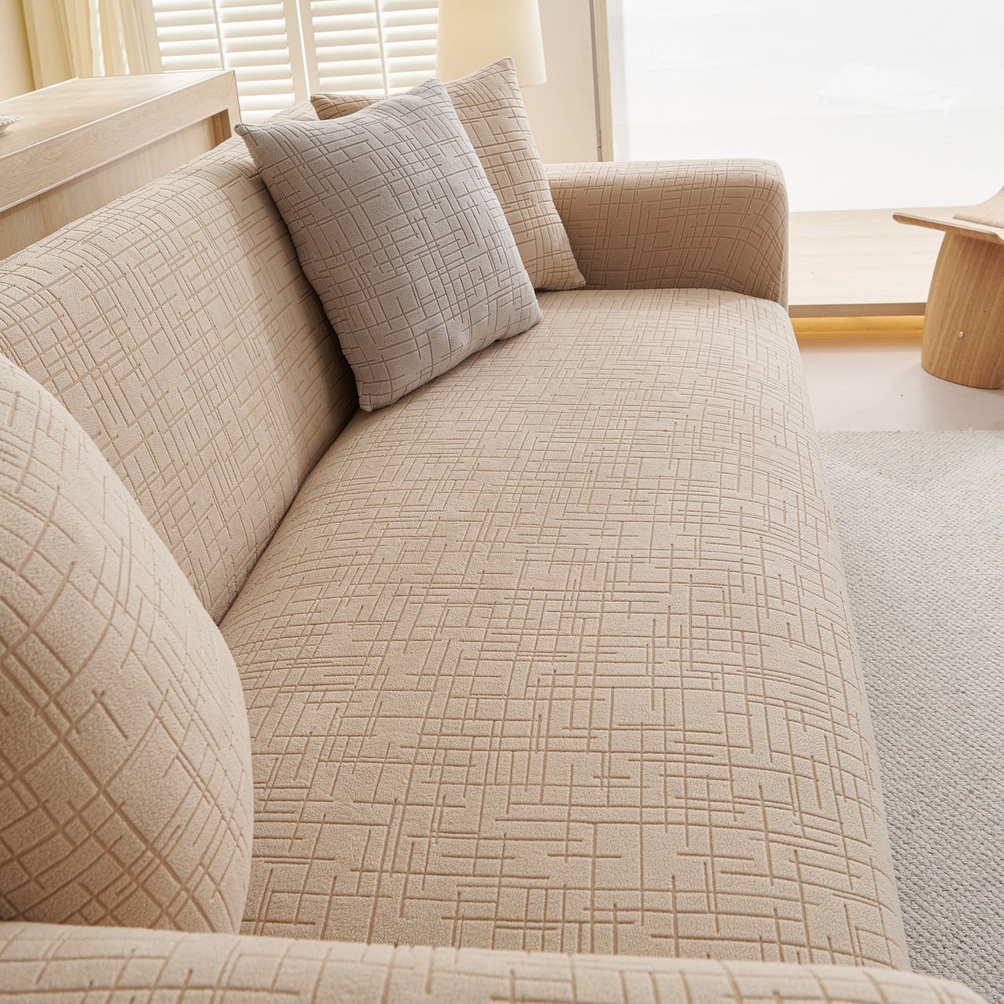 Embossed Lines Couch Covers Stretchable Non-Slip & Washable Sofa Slipcovers on beige sofa, showcasing secure fit and breathable material.