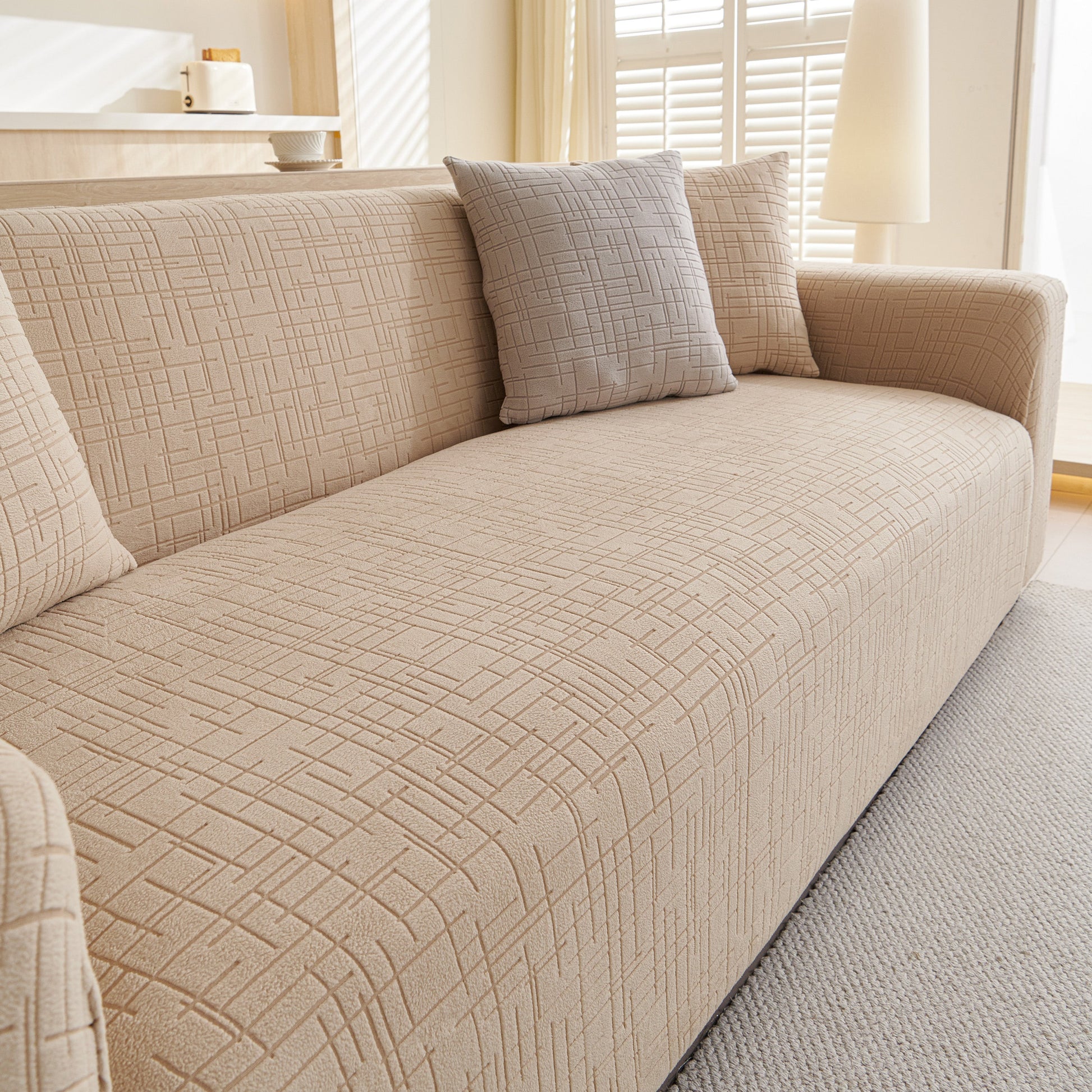 Embossed Lines Couch Covers Stretchable Non-Slip & Washable Sofa Slipcovers on beige sofa with grey pillow