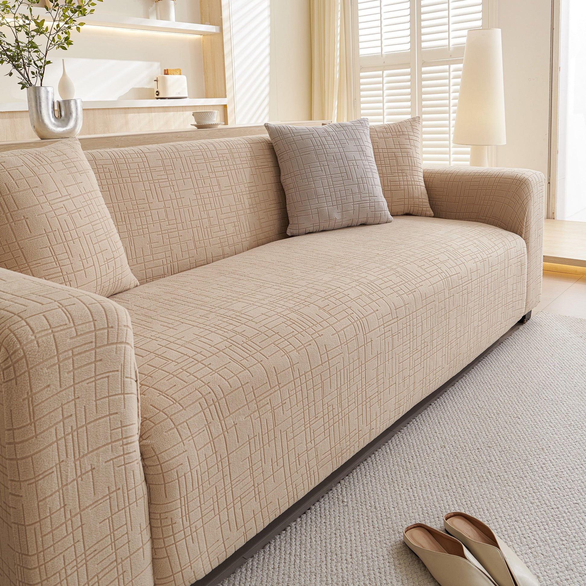Beige Embossed Lines Couch Covers Stretchable Non-Slip & Washable Sofa Slipcovers on a modern sofa