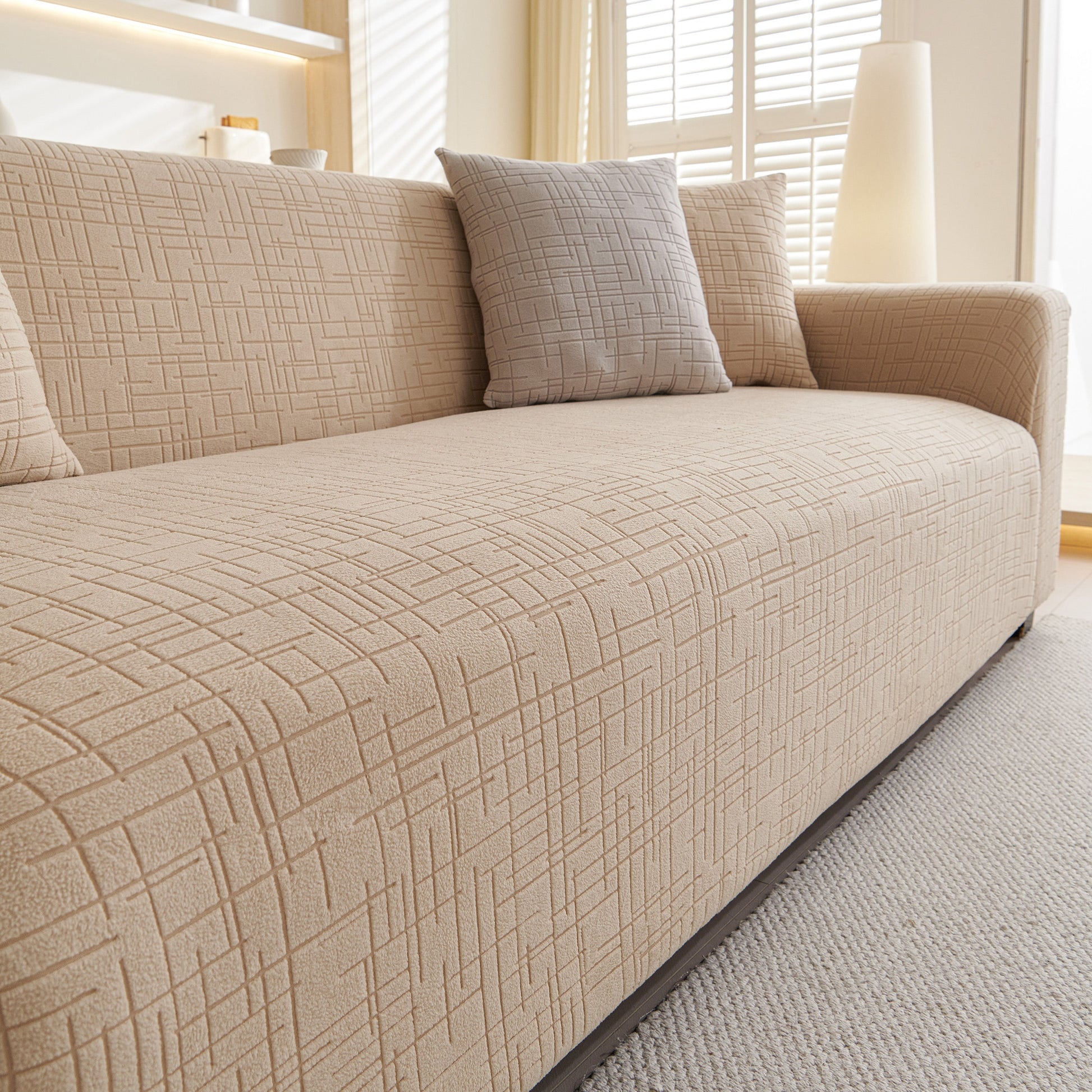 Embossed Lines Couch Covers Stretchable Non-Slip & Washable Sofa Slipcovers in beige on a modern sofa with cushions