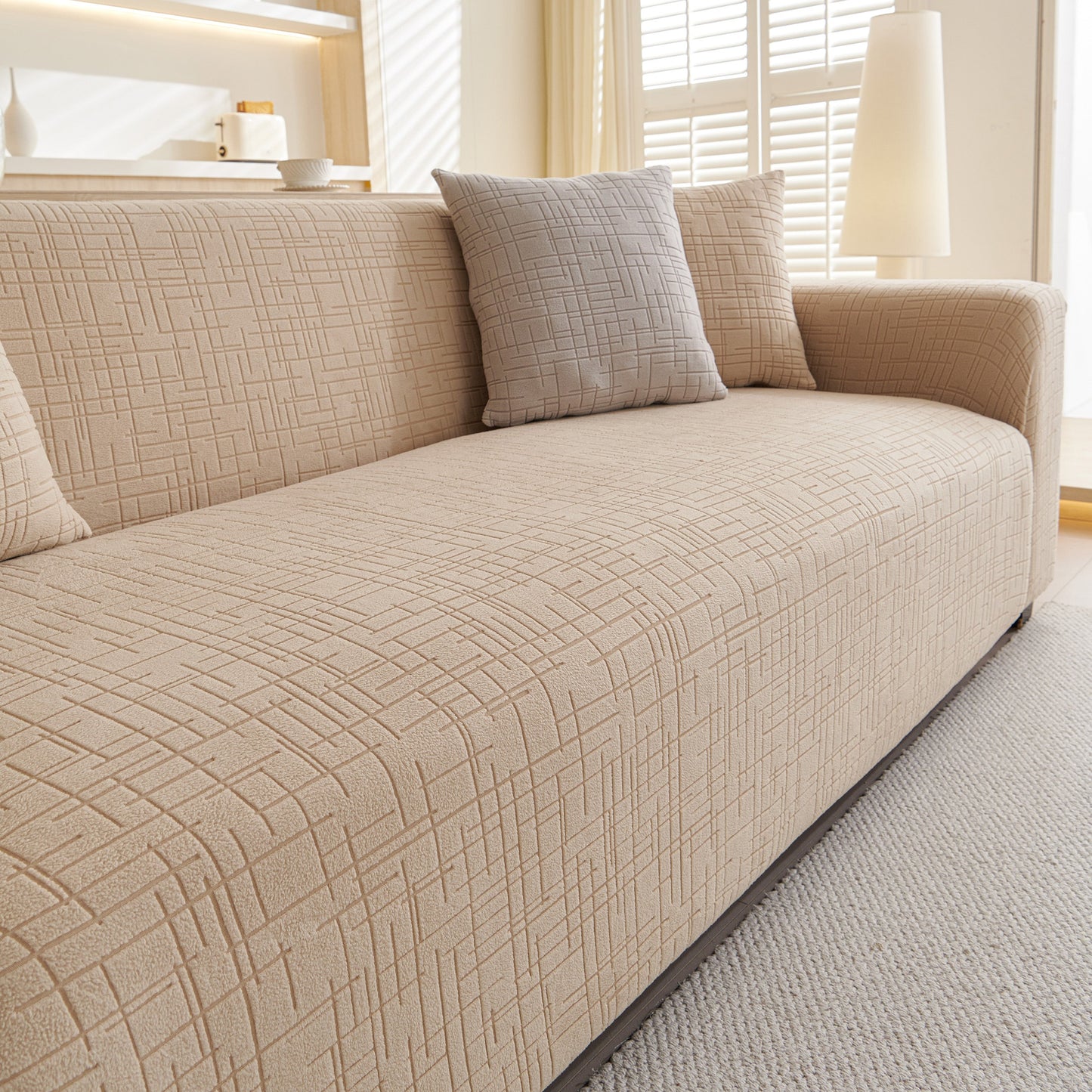 Embossed Lines Couch Covers Stretchable Non-Slip & Washable Sofa Slipcovers on a beige sofa in a bright living room.