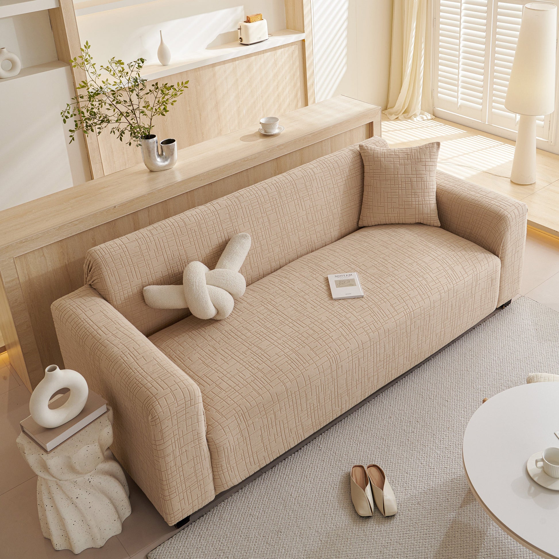 Modern living room with a beige sofa featuring Embossed Lines Couch Covers Stretchable Non-Slip & Washable Sofa Slipcovers for style and protection.