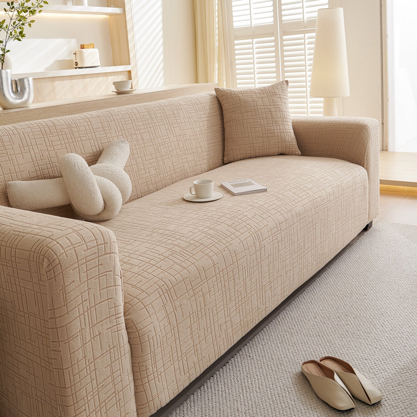 Embossed Lines Couch Covers Stretchable Non-Slip & Washable Sofa Slipcovers in beige on a modern sofa.