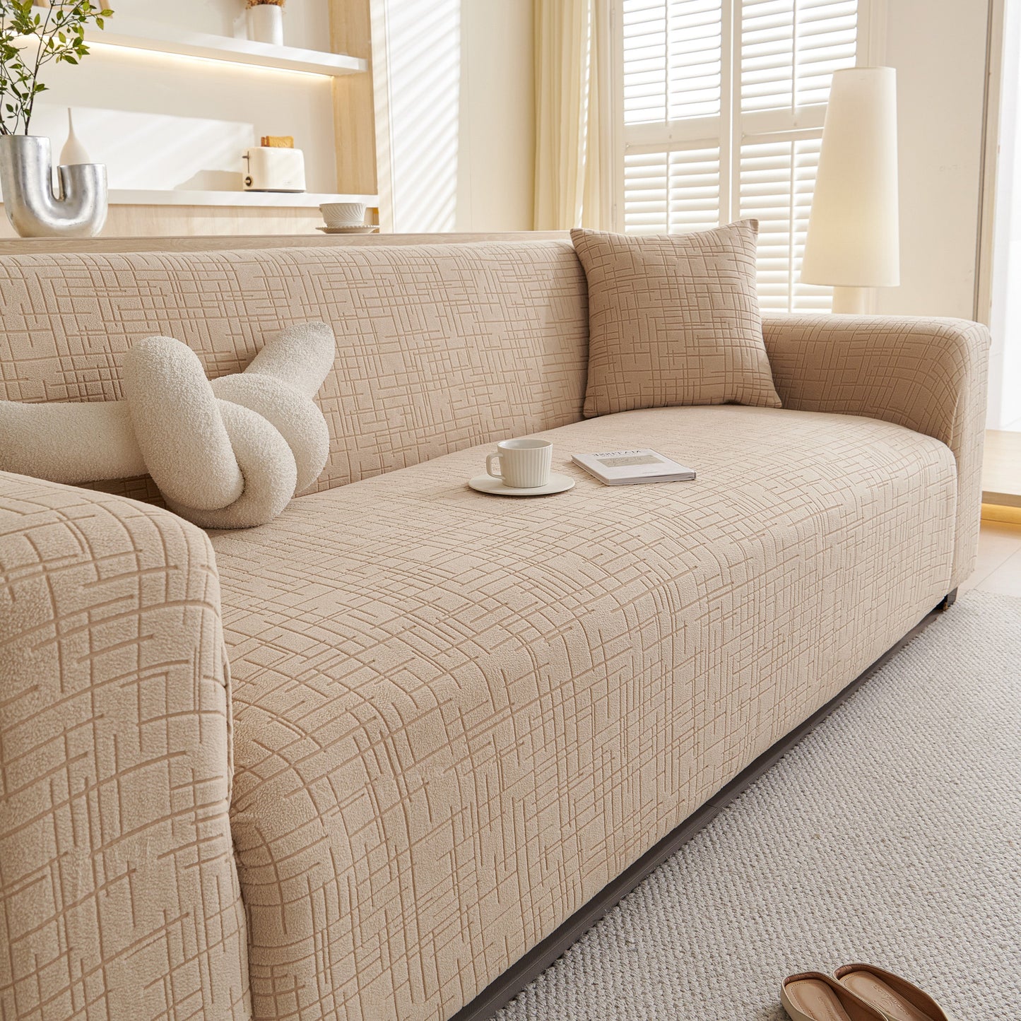 Embossed Lines Couch Covers Stretchable Non-Slip & Washable Sofa Slipcovers on a stylish beige sofa in a cozy living room.