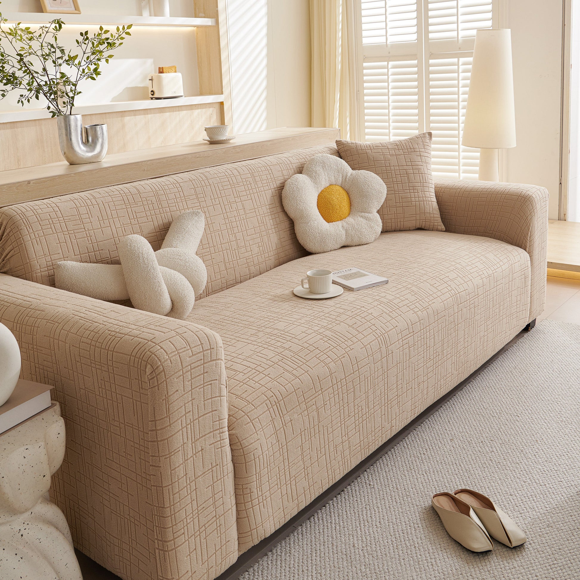 Embossed Lines Couch Covers Stretchable Non-Slip & Washable Sofa Slipcovers displayed on a beige sofa in a living room setting.