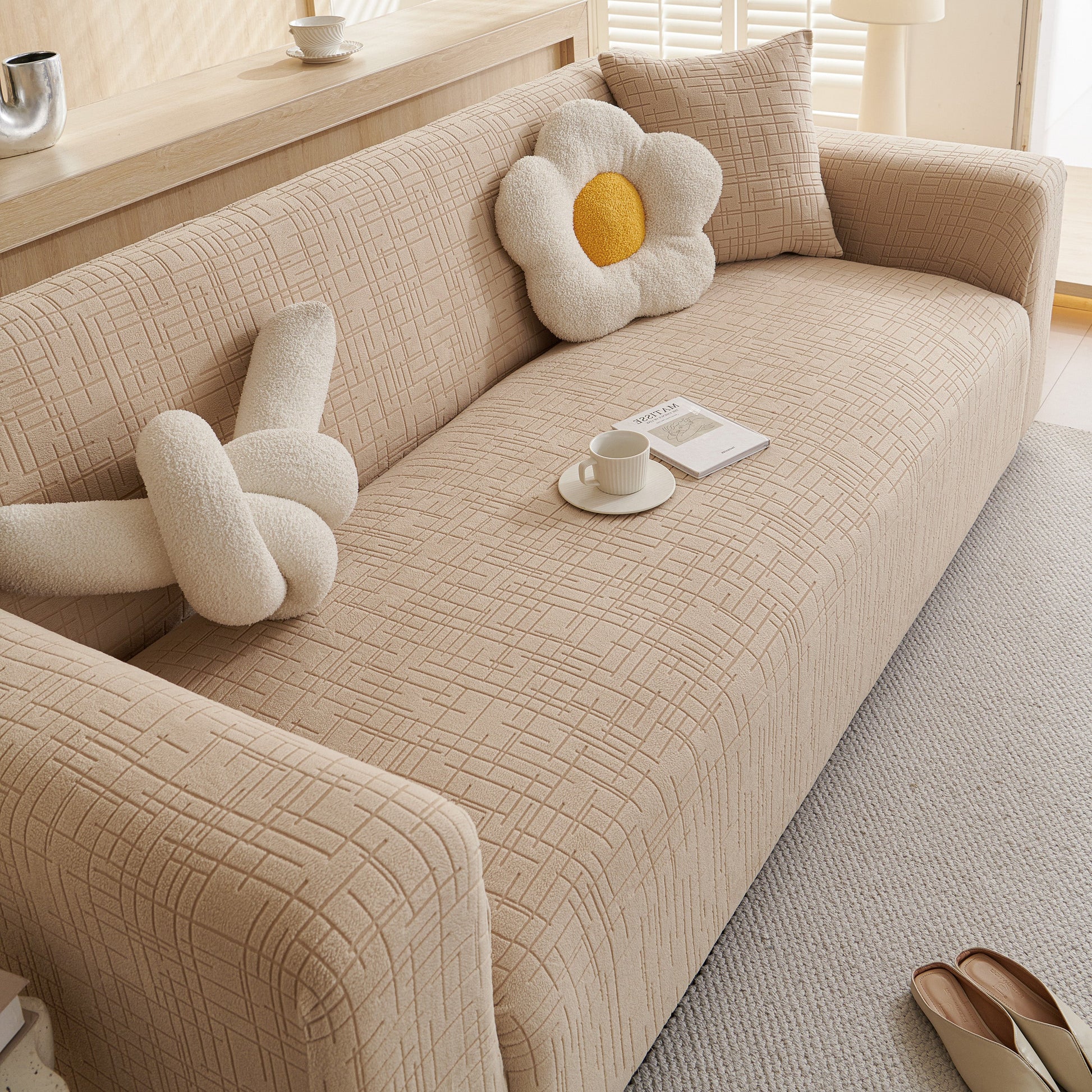 Embossed Lines Couch Covers Stretchable Non-Slip & Washable Sofa Slipcovers on beige couch with decorative pillows.