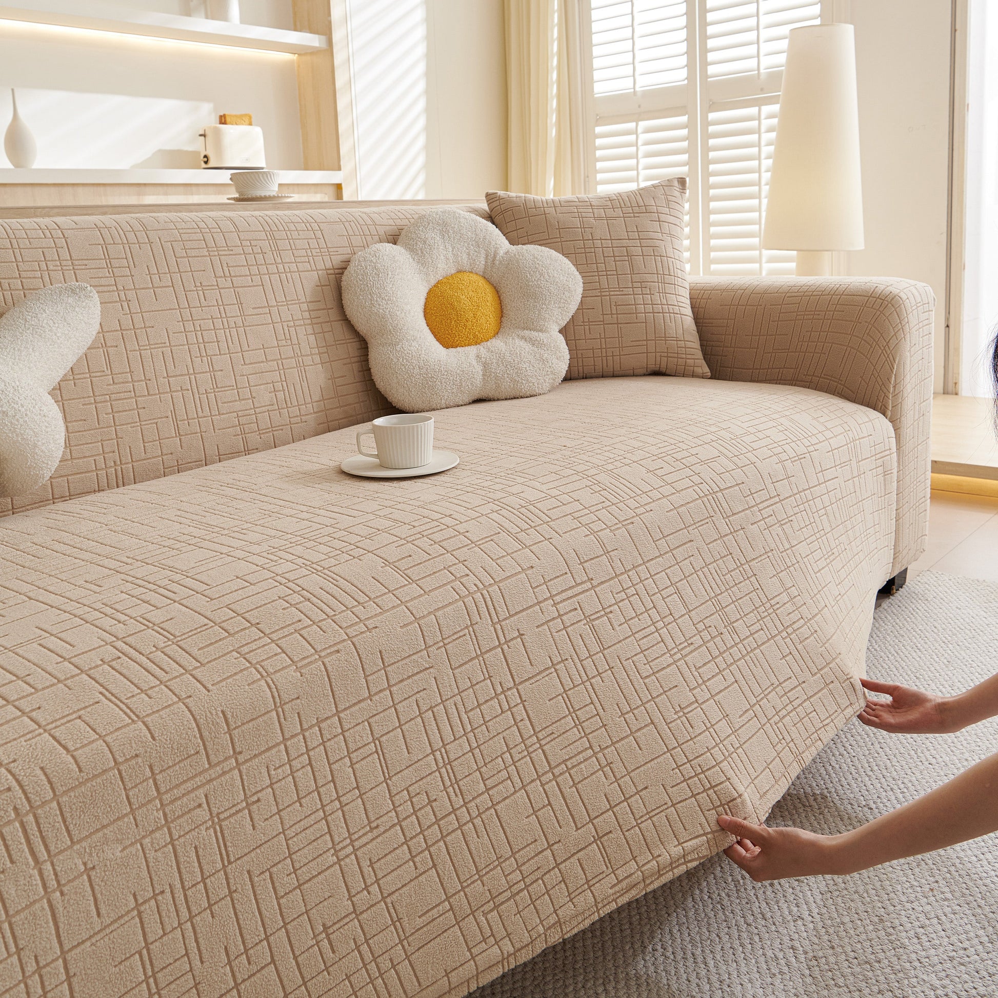 Living room with Embossed Lines Couch Covers Stretchable Non-Slip & Washable Sofa Slipcovers on beige sofa with decorative pillows.