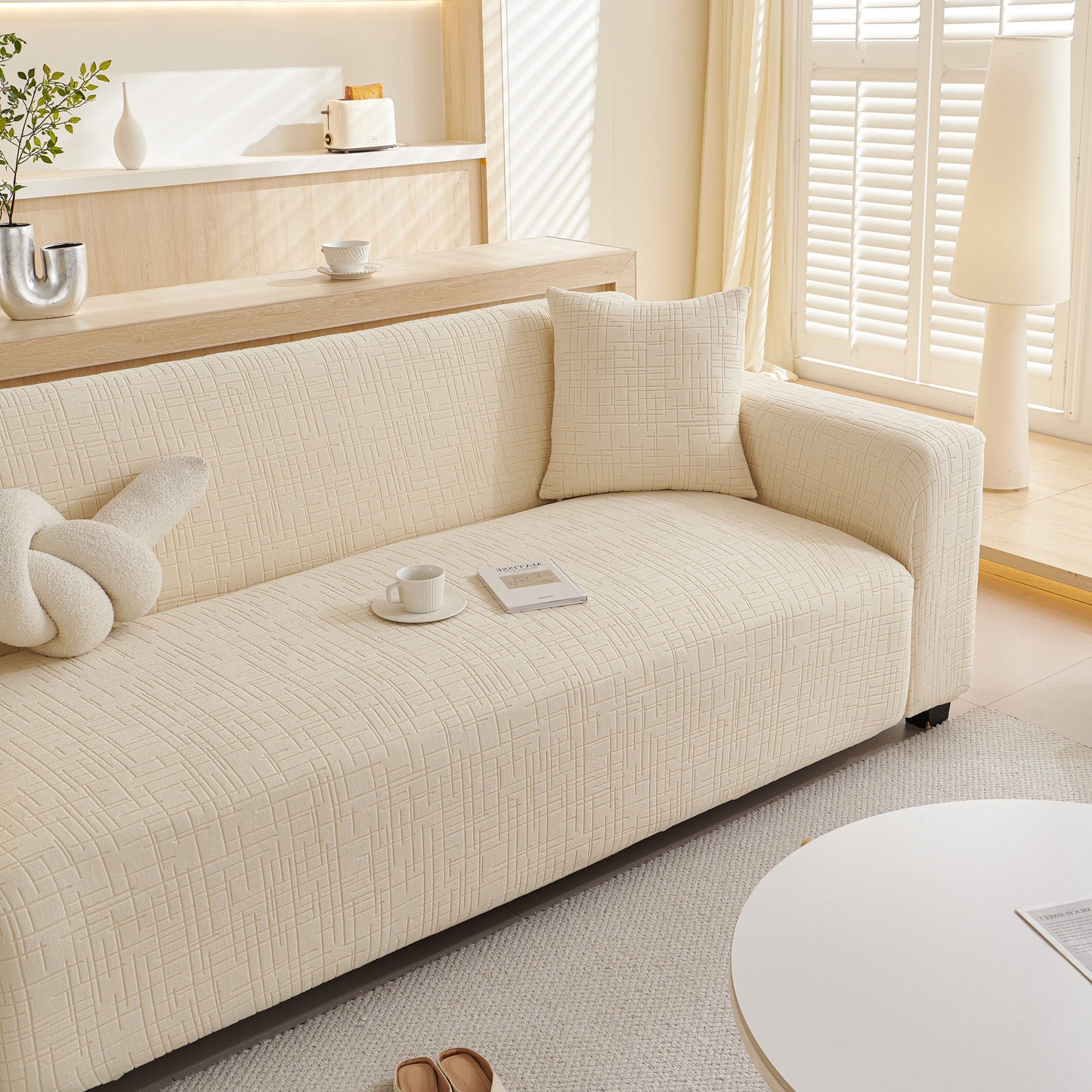 Embossed Lines Couch Covers Stretchable Non-Slip & Washable Sofa Slipcovers on a beige sofa in a bright living room