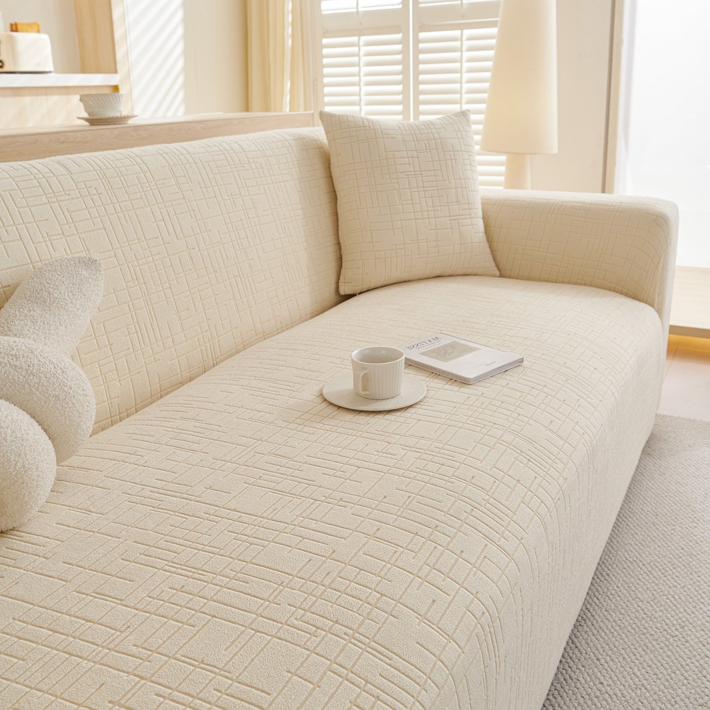 Embossed Lines Couch Covers Stretchable Non-Slip & Washable Sofa Slipcovers on a beige sofa in a bright living room