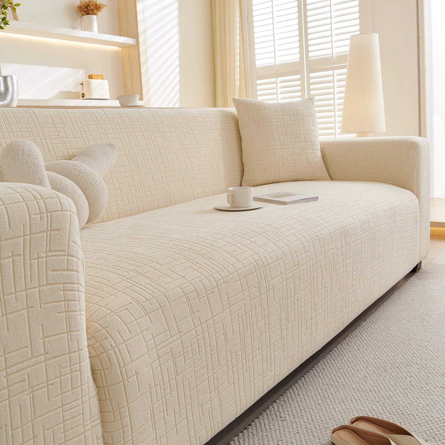 Embossed Lines Couch Covers Stretchable Non-Slip & Washable Sofa Slipcovers on modern beige couch in bright living room.