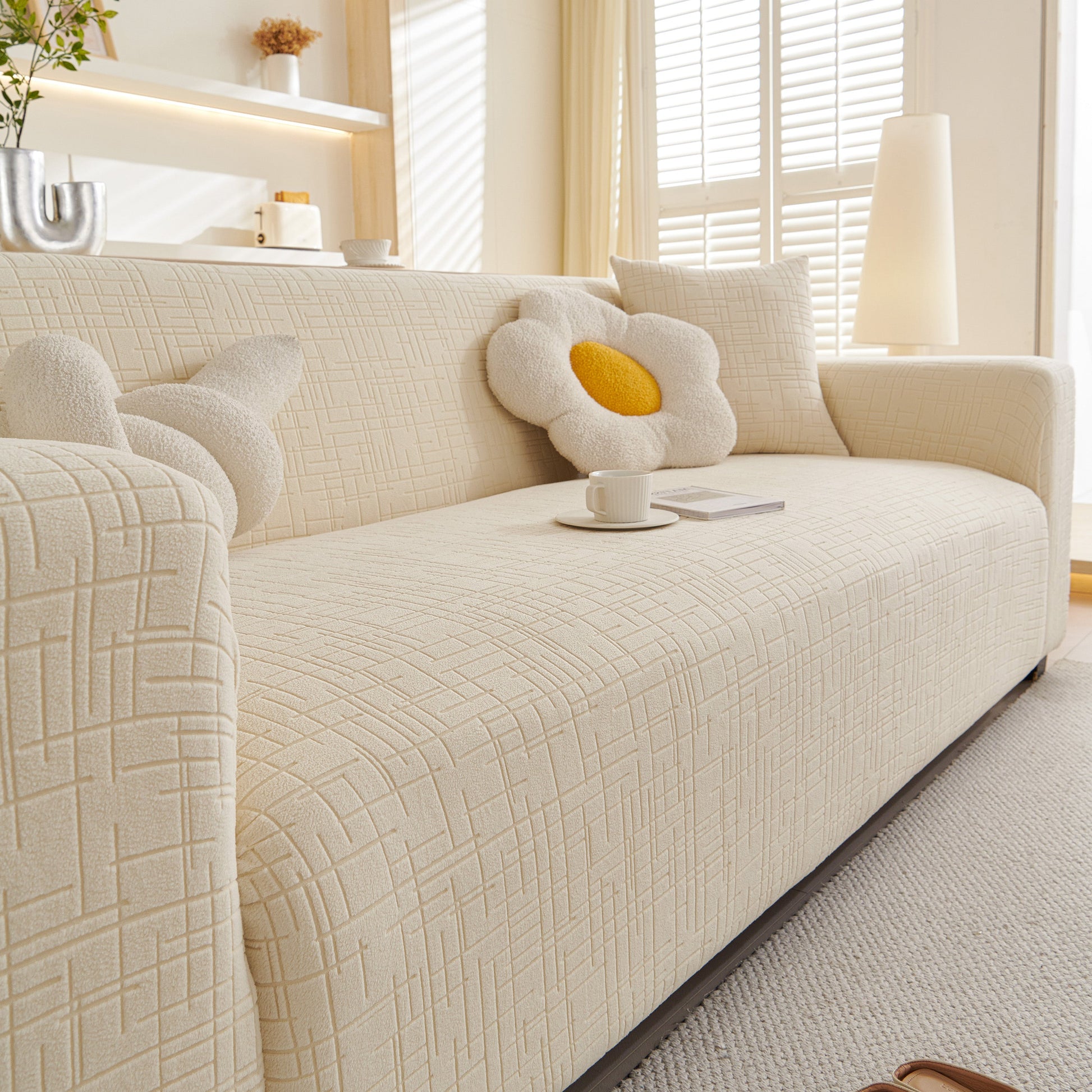 Embossed Lines Couch Covers Stretchable Non-Slip & Washable Sofa Slipcovers on a beige couch with decorative pillows.
