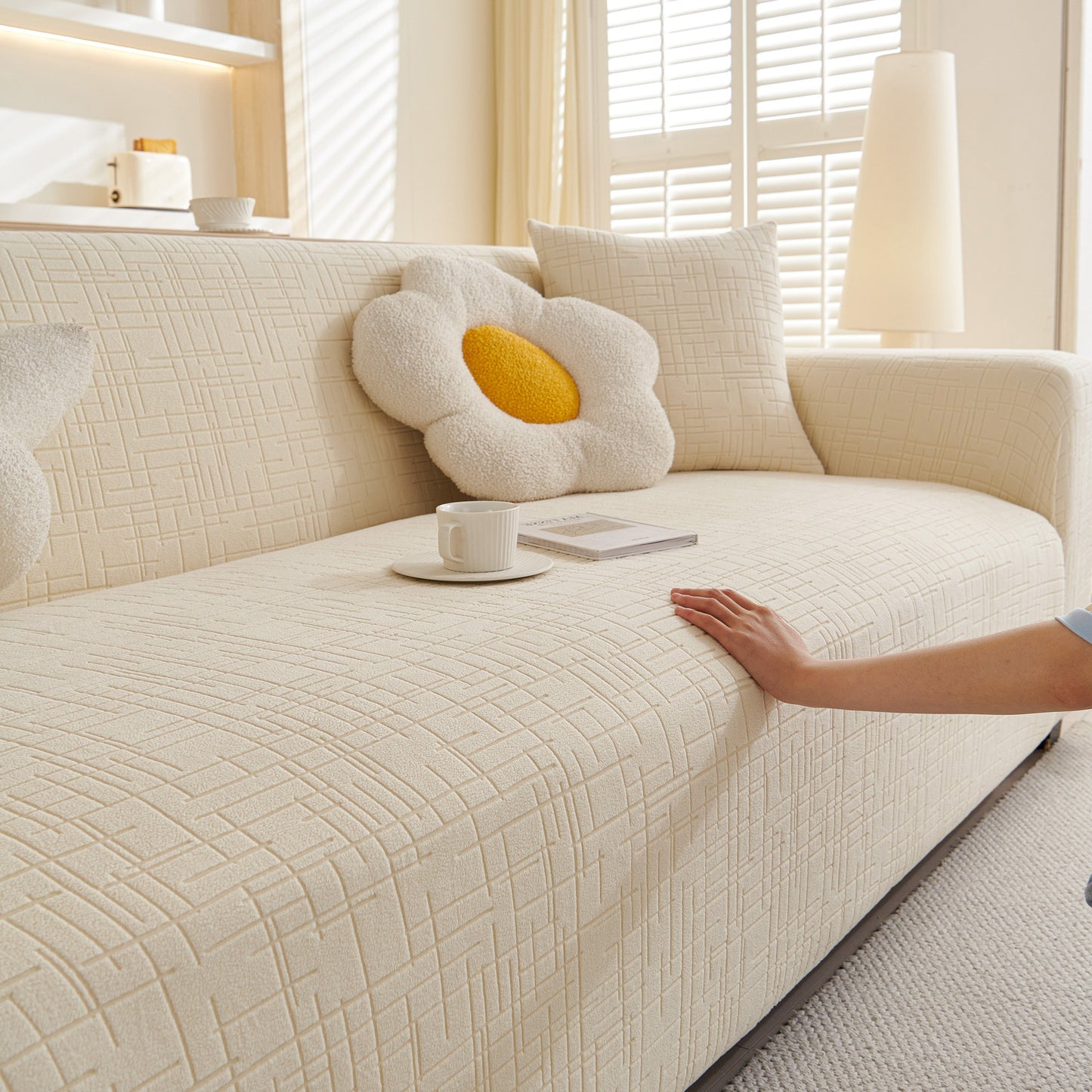 Embossed Lines Couch Covers Stretchable Non-Slip & Washable Sofa Slipcovers on a beige couch with flower-shaped pillows.