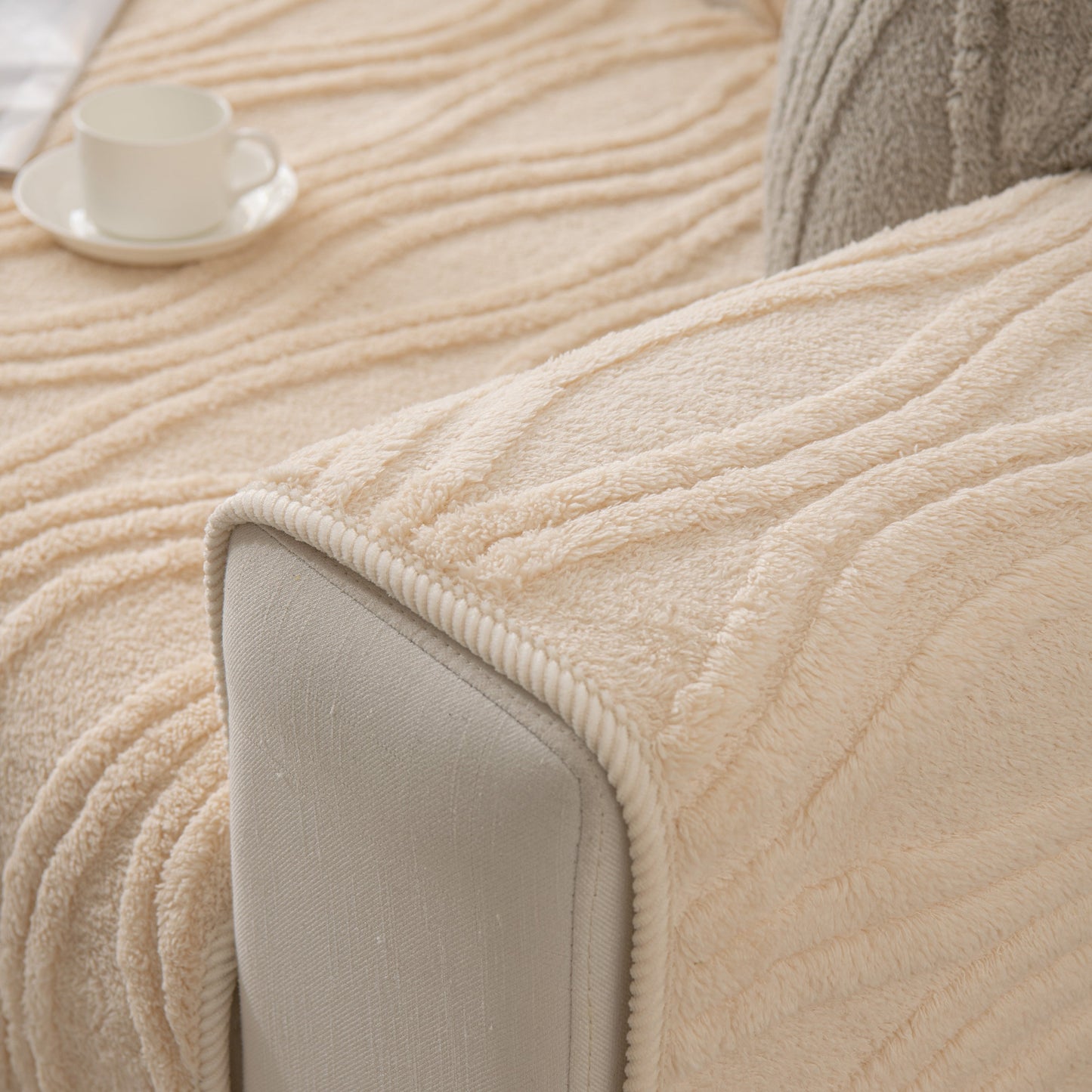 Winter Thickened Non-slip Blanket, Three-Dimensional Embossed Cotton Velvet Sofa Cover draped over a beige sofa armrest