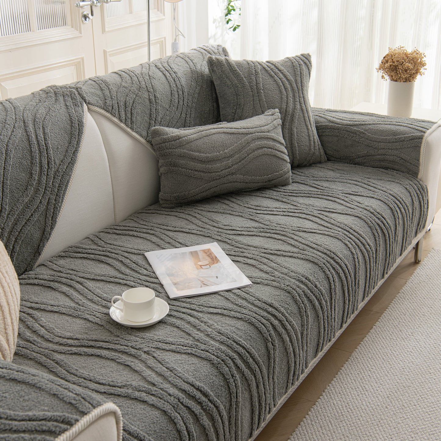 Winter Thickened Non-slip Blanket, Three-Dimensional Embossed Cotton Velvet Sofa Cover on a modern grey sofa with cushions.