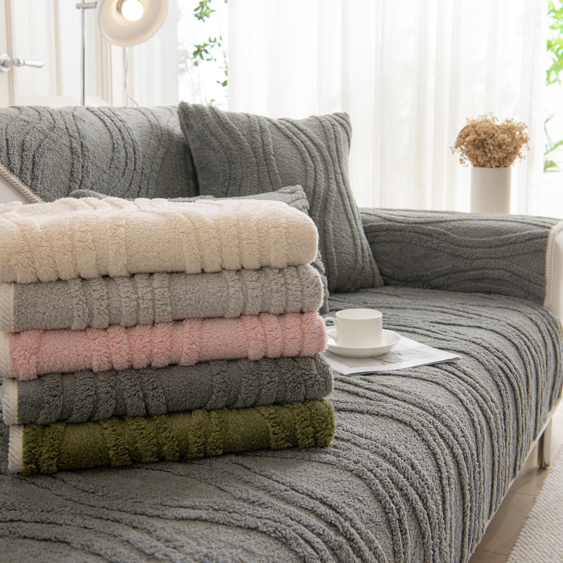 Winter Thickened Non-slip Blanket, Three-Dimensional Embossed Cotton Velvet Sofa Cover on gray sofa, stack of blankets in various colors