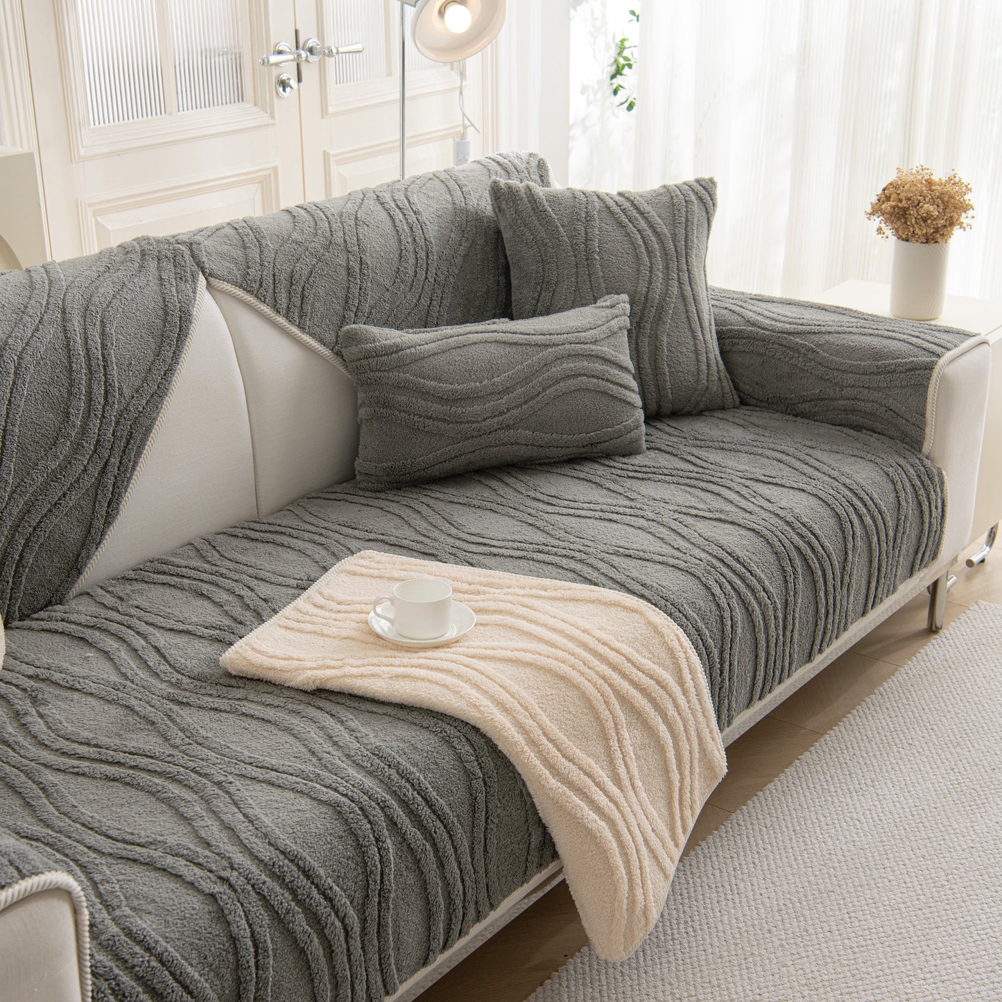 Winter Thickened Non-slip Blanket, Three-Dimensional Embossed Cotton Velvet Sofa Cover on a stylish grey sofa with matching pillows.