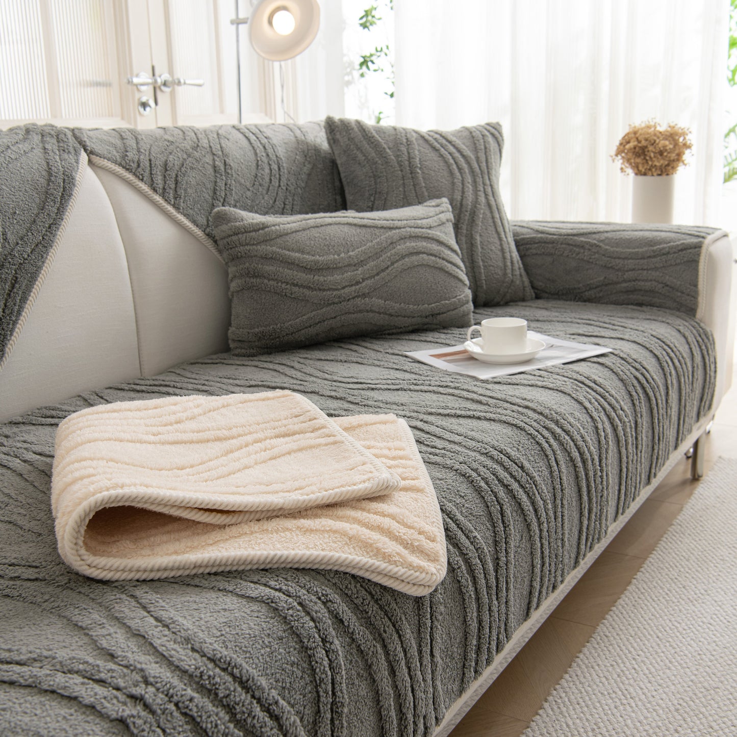 Winter Thickened Non-slip Blanket, Three-Dimensional Embossed Cotton Velvet Sofa Cover on a sofa with pillows and a coffee cup.