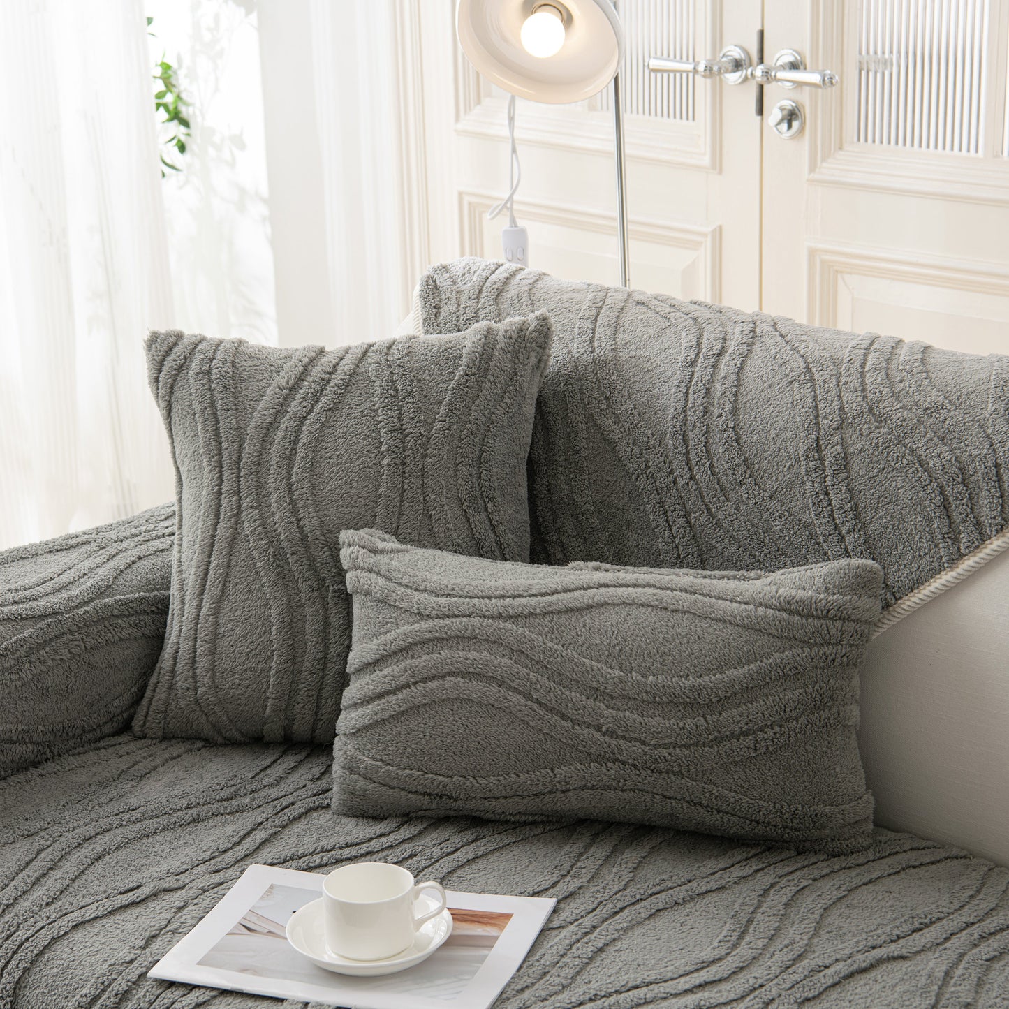 Winter Thickened Non-slip Blanket, Three-Dimensional Embossed Cotton Velvet Sofa Cover on a grey couch with pillows.