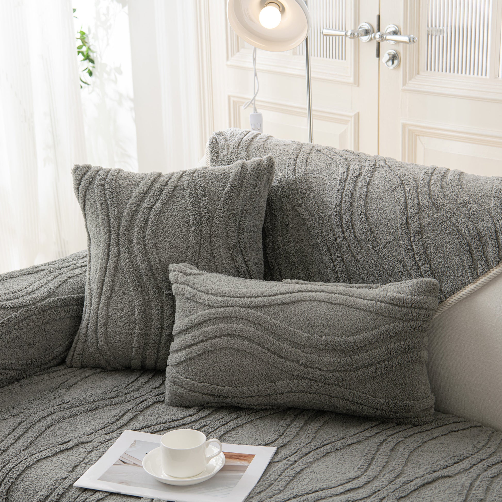 Winter Thickened Non-slip Blanket, Three-Dimensional Embossed Cotton Velvet Sofa Cover on a grey couch with pillows.