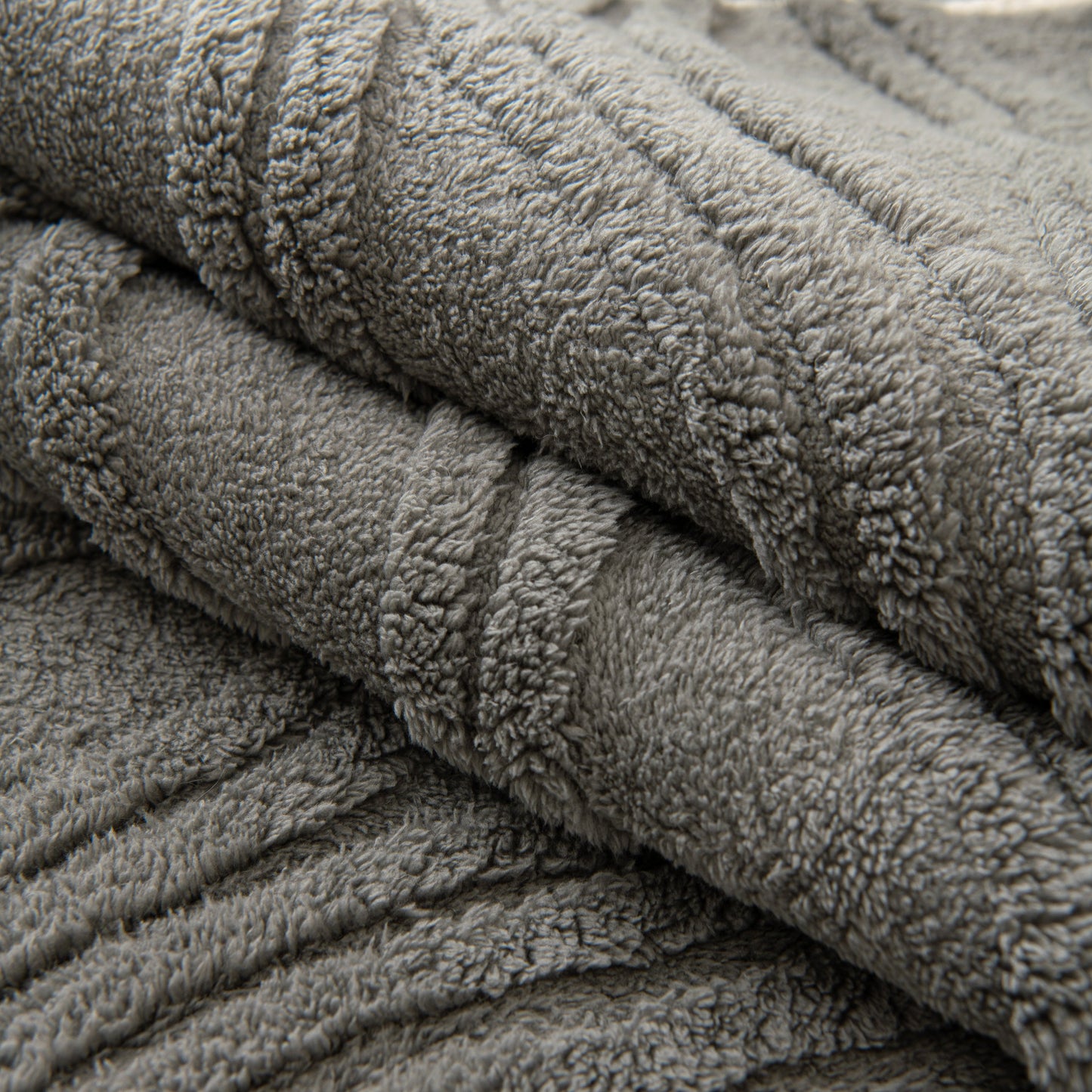 Winter Thickened Non-slip Blanket, Three-Dimensional Embossed Cotton Velvet Sofa Cover with textured surface in grey.