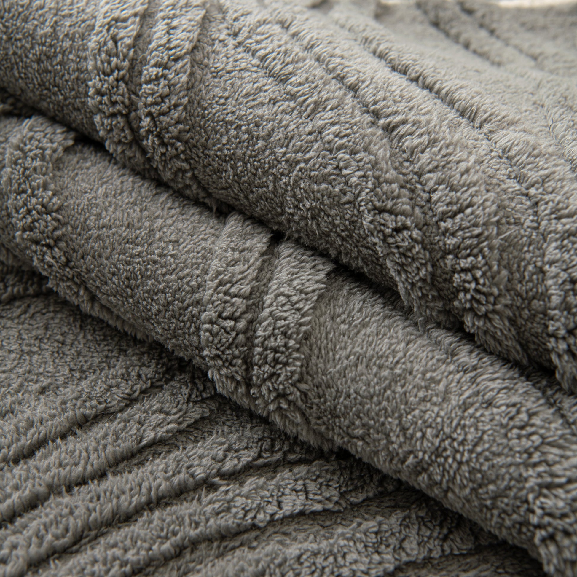 Winter Thickened Non-slip Blanket, Three-Dimensional Embossed Cotton Velvet Sofa Cover with textured surface in grey.