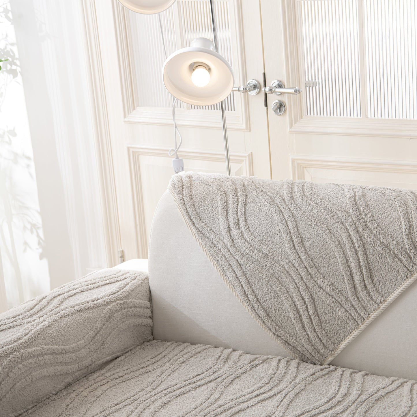 Winter Thickened Non-slip Blanket, Three-Dimensional Embossed Cotton Velvet Sofa Cover on a cream sofa in a bright room.