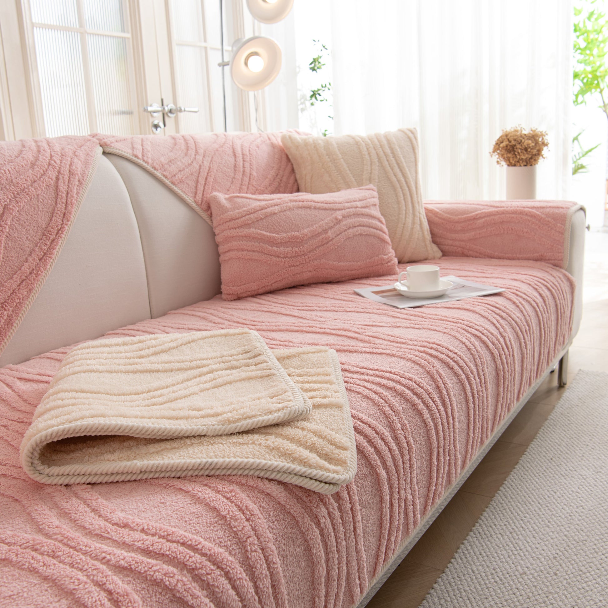 Winter Thickened Non-slip Blanket, Three-Dimensional Embossed Cotton Velvet Sofa Cover draped over a modern sofa in a bright room.