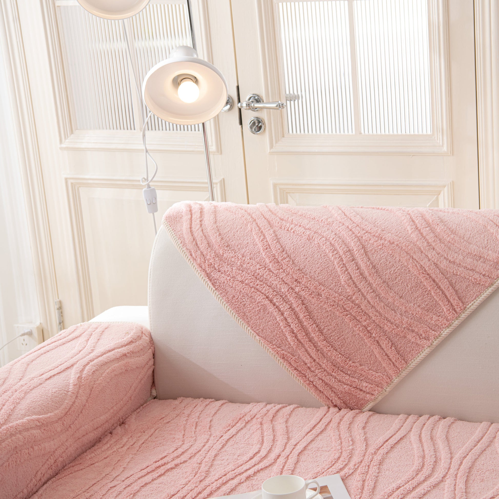 Winter Thickened Non-slip Blanket, Three-Dimensional Embossed Cotton Velvet Sofa Cover in pink on a sofa.
