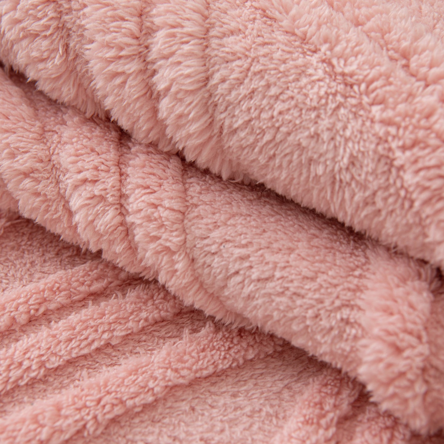 Close-up of a Winter Thickened Non-slip Blanket, Three-Dimensional Embossed Cotton Velvet Sofa Cover in soft pink color.