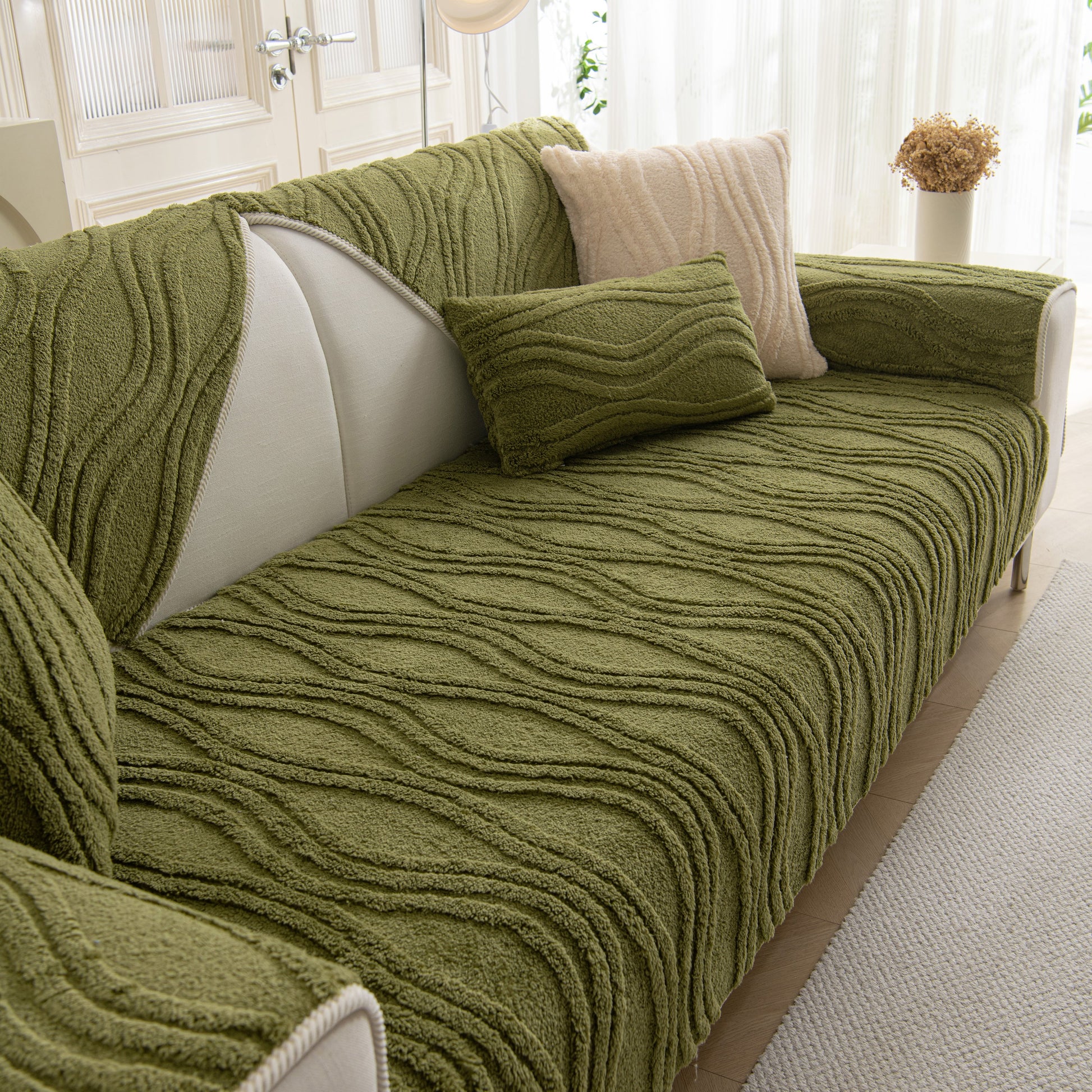 Winter Thickened Non-slip Blanket, Three-Dimensional Embossed Cotton Velvet Sofa Cover in green on a light-colored sofa in a cozy room.