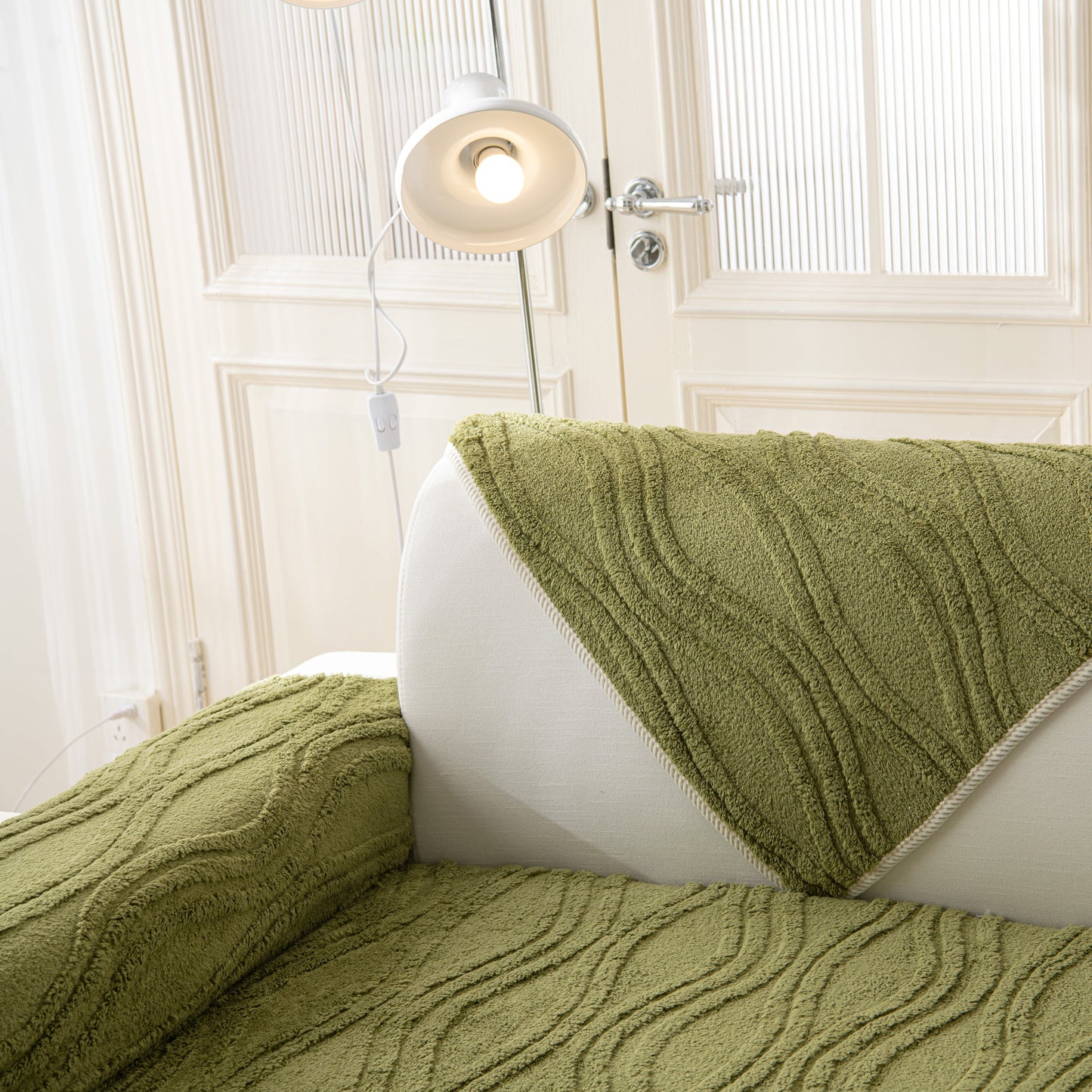 Winter Thickened Non-slip Blanket, Three-Dimensional Embossed Cotton Velvet Sofa Cover on a white couch with lamp in the background