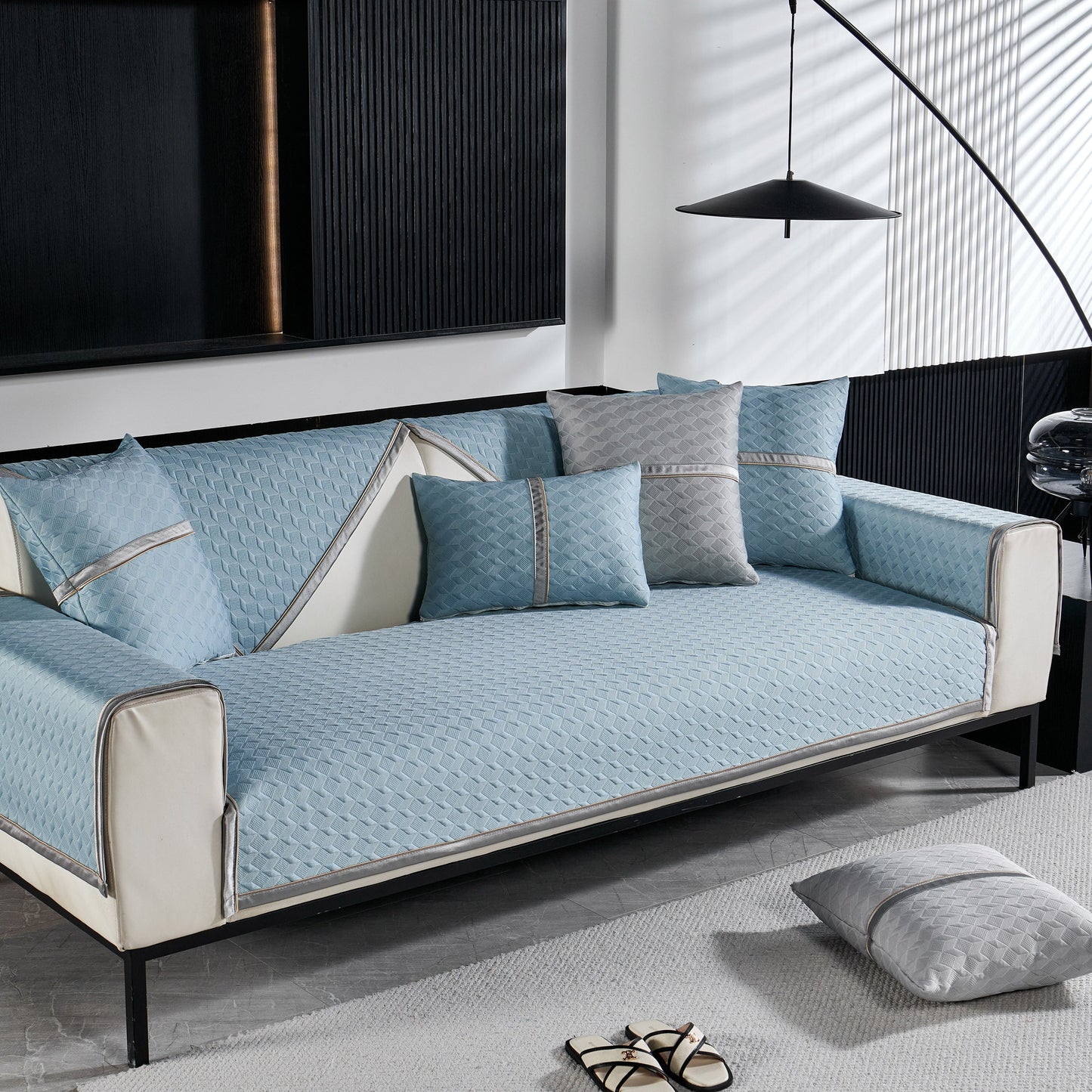 Geometric 3D Sofa Cover, Non-Slip Couch Protector for Seat, Backrest & Armrest in blue with diamond quilted pattern on a modern sofa.