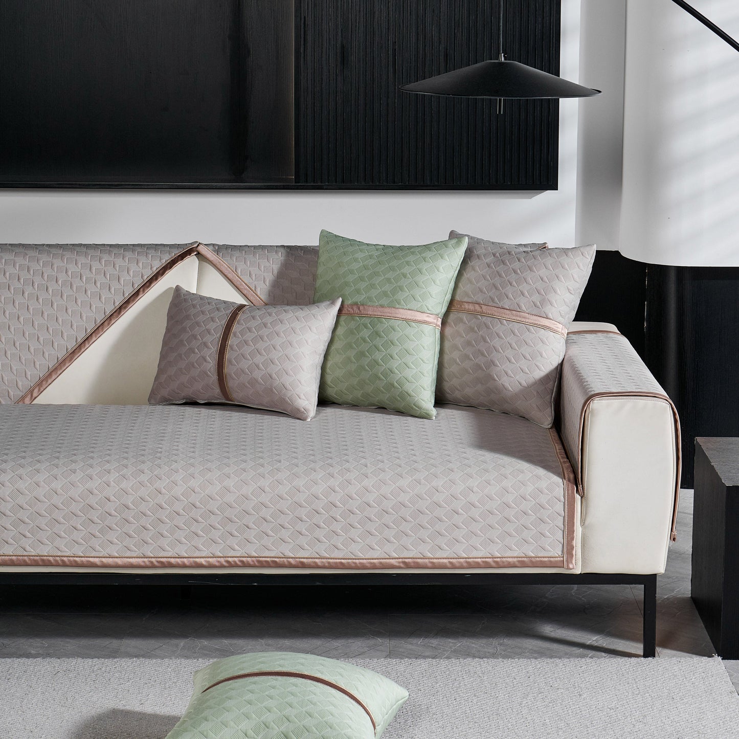 Modern gray sofa with Geometric 3D Sofa Cover, Non-Slip Couch Protector for Seat, Backrest & Armrest, featuring quilted design and cushions.