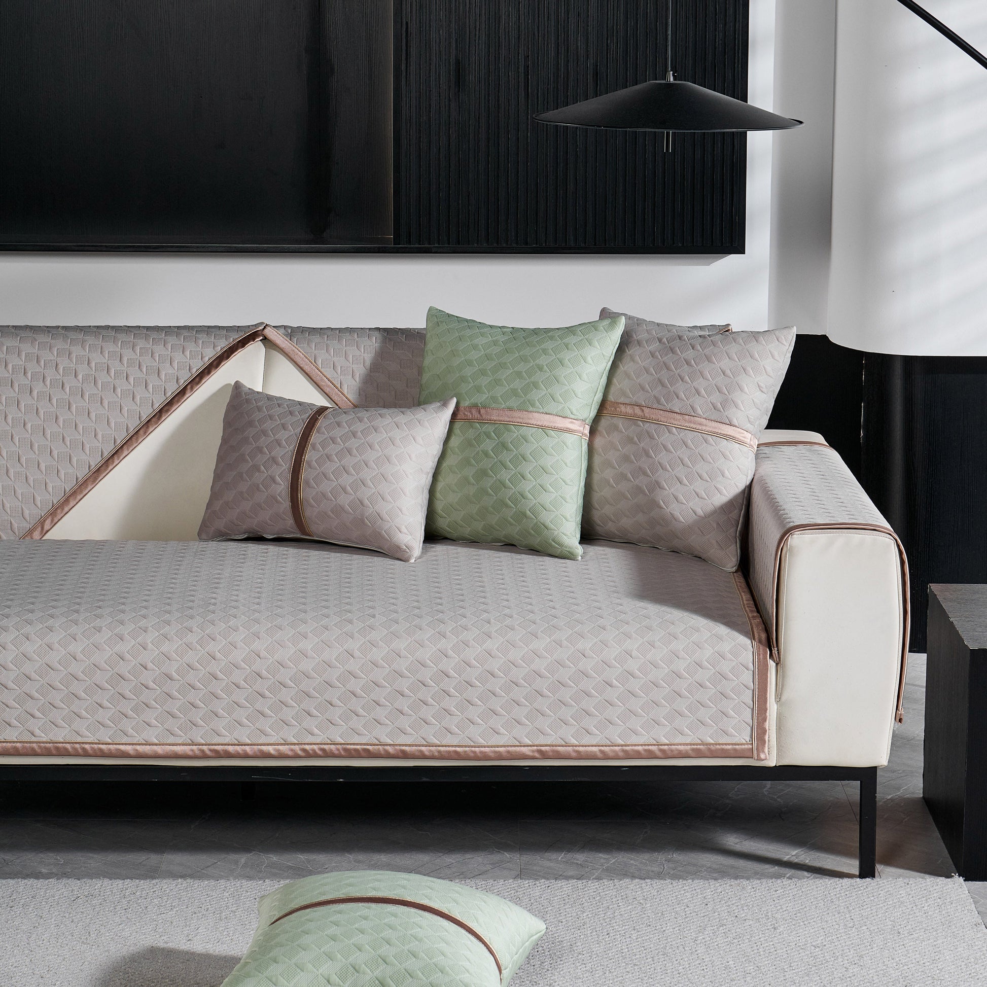 Modern gray sofa with Geometric 3D Sofa Cover, Non-Slip Couch Protector for Seat, Backrest & Armrest, featuring quilted design and cushions.