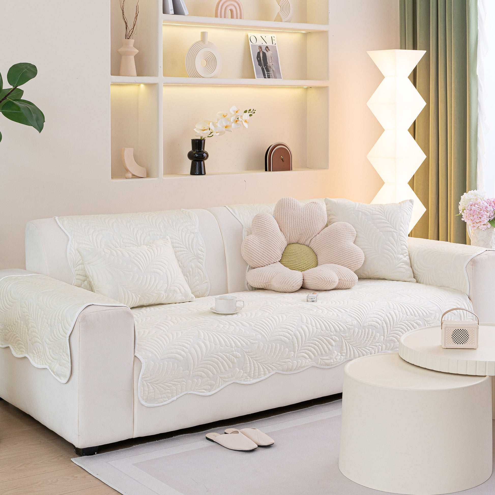 Sofa Cover for Leather & Fabric Couches, 3D Leaf Embossed Quilted Furniture Covers on a stylish modern white sofa.