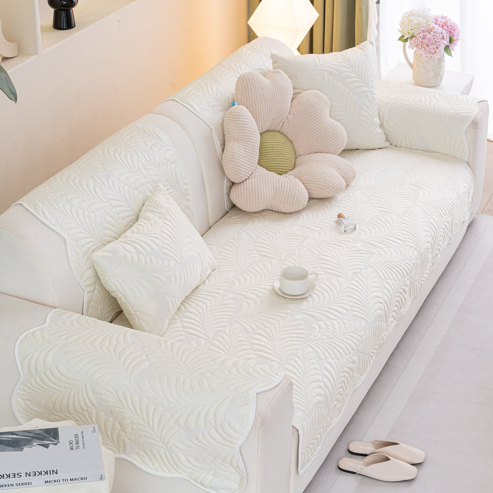 Sofa Cover for Leather & Fabric Couches, 3D Leaf Embossed Quilted Furniture Covers, shown on a white couch with decorative pillows