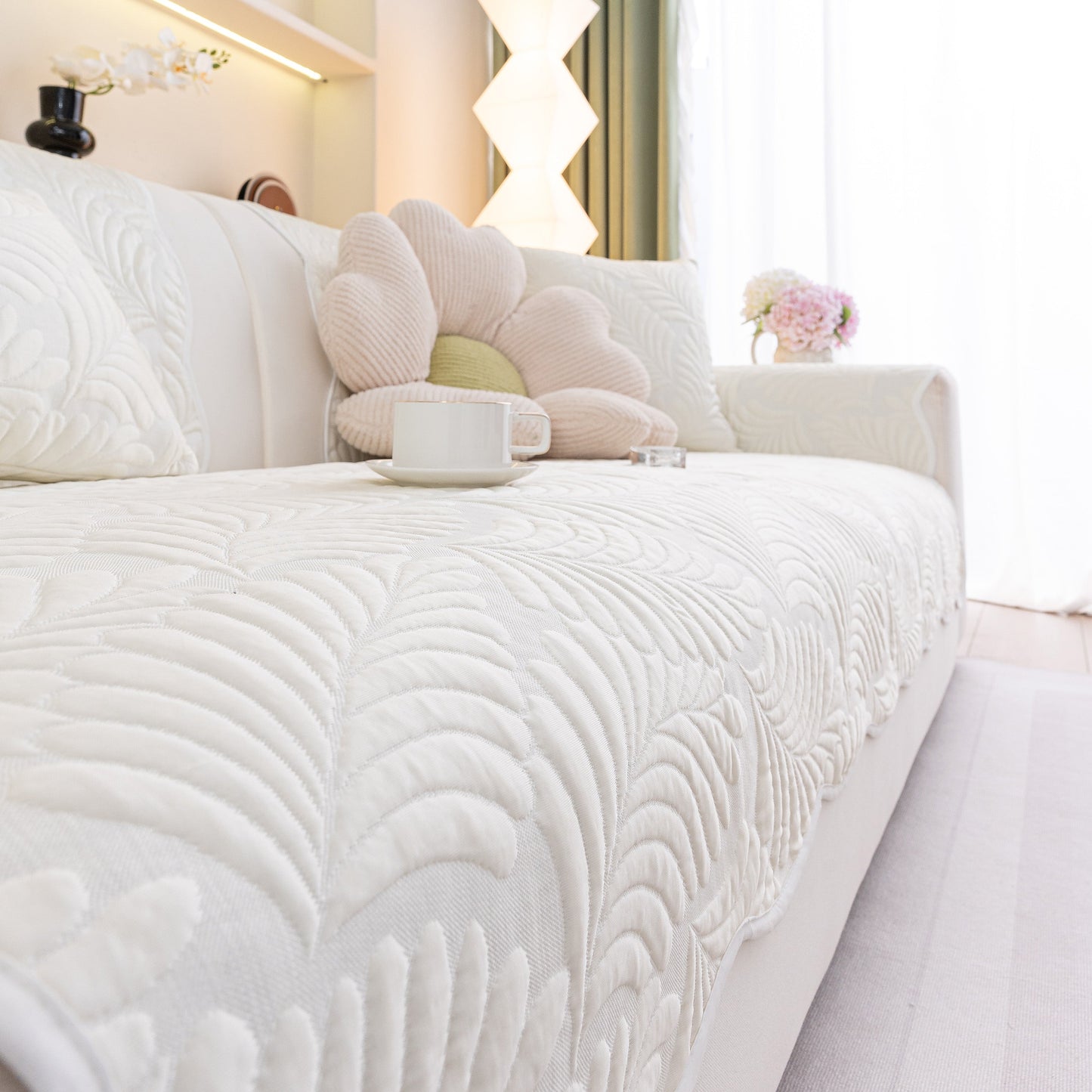 Sofa Cover for Leather & Fabric Couches, 3D Leaf Embossed Quilted Furniture Covers with anti-slip backing on a white couch.