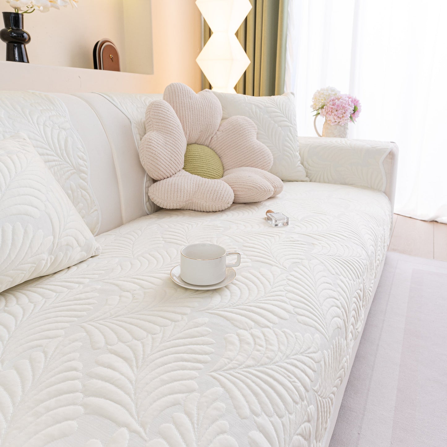 Sofa Cover for Leather & Fabric Couches, 3D Leaf Embossed Quilted Furniture Covers with flower pillow and cup on a white couch