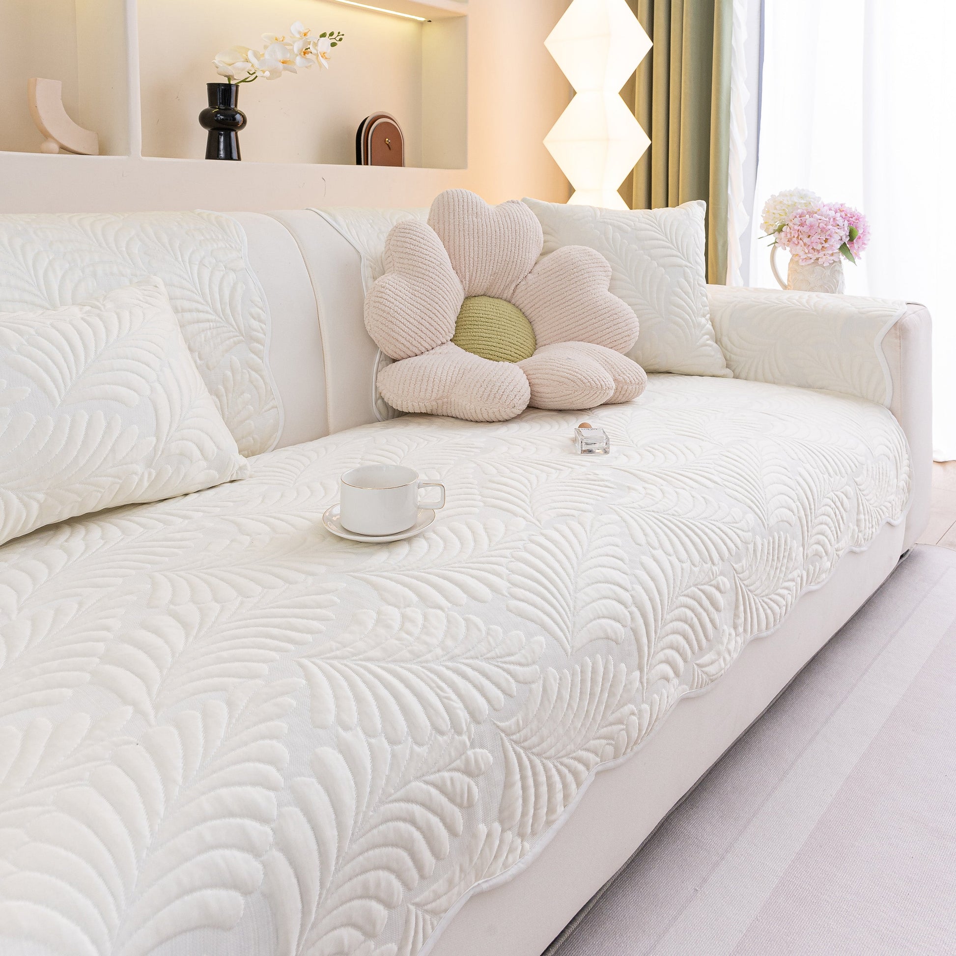 Sofa Cover for Leather & Fabric Couches, 3D Leaf Embossed Quilted Furniture Covers on white sofa with floral pillow.