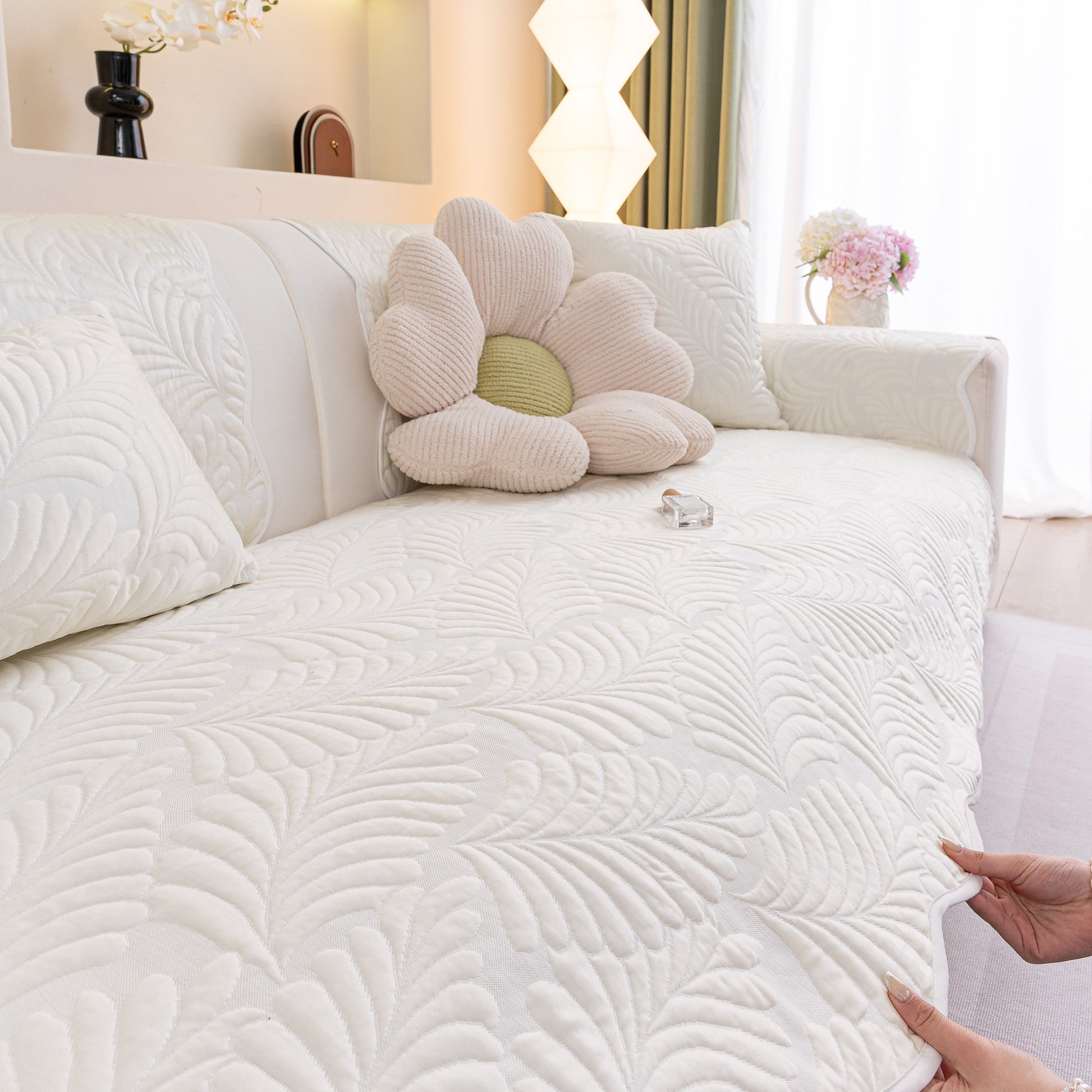 Sofa Cover for Leather & Fabric Couches, 3D Leaf Embossed Quilted Furniture Covers showcasing its embossed leaf pattern on a couch.