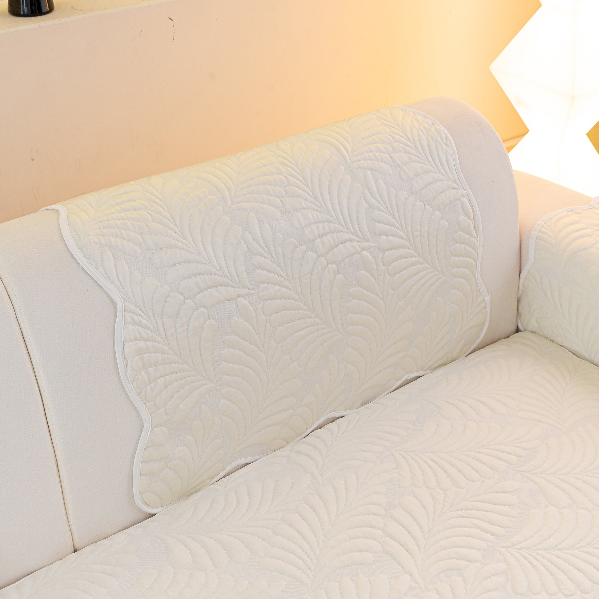 Sofa Cover for Leather & Fabric Couches, 3D Leaf Embossed Quilted Furniture Covers on a white couch, showcasing anti-slip design.