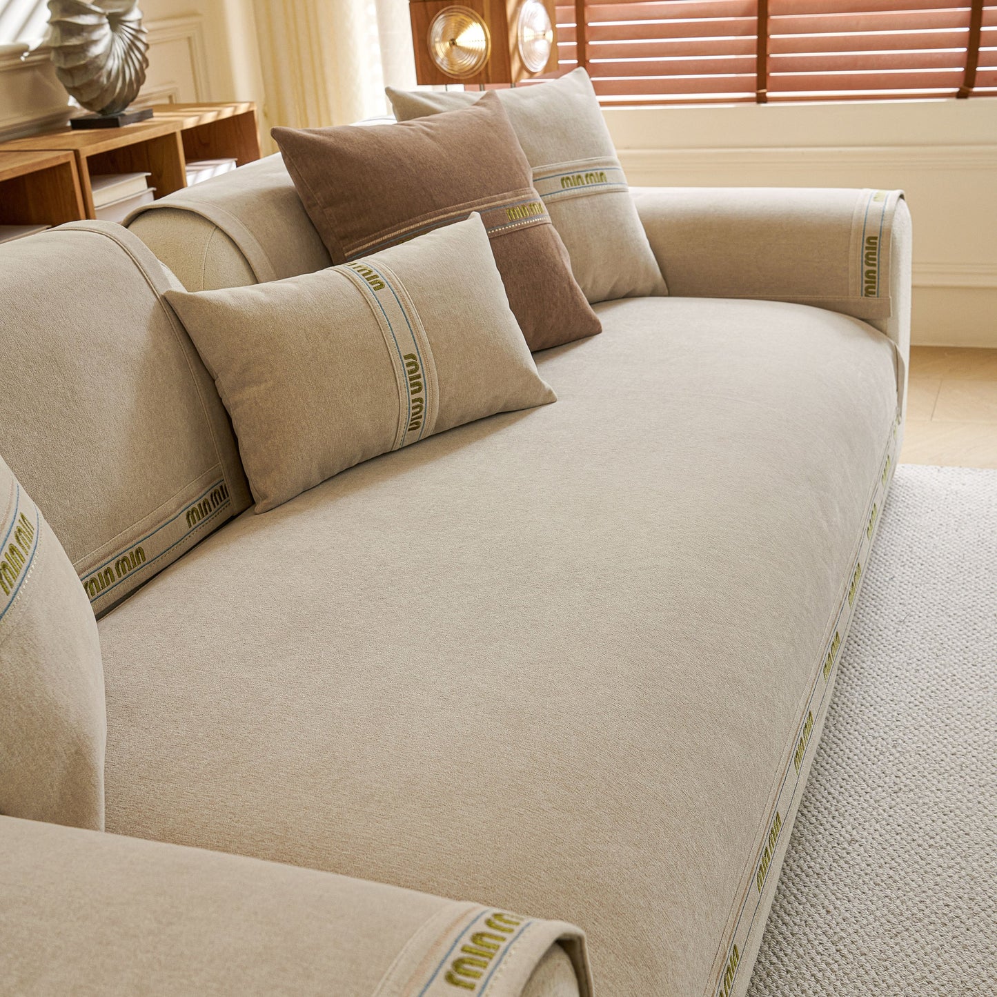 Chenille Sofa Cover Pet Mat, Non-Slip Couch Protector for Sectional & L-Shaped Sofas on a beige couch with matching pillows.