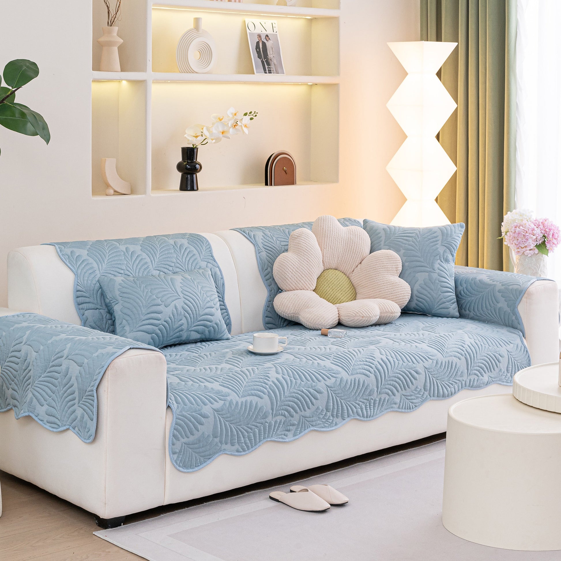 Sofa Cover for Leather & Fabric Couches, 3D Leaf Embossed Quilted Furniture Covers displayed on a white sofa in a stylish living room.