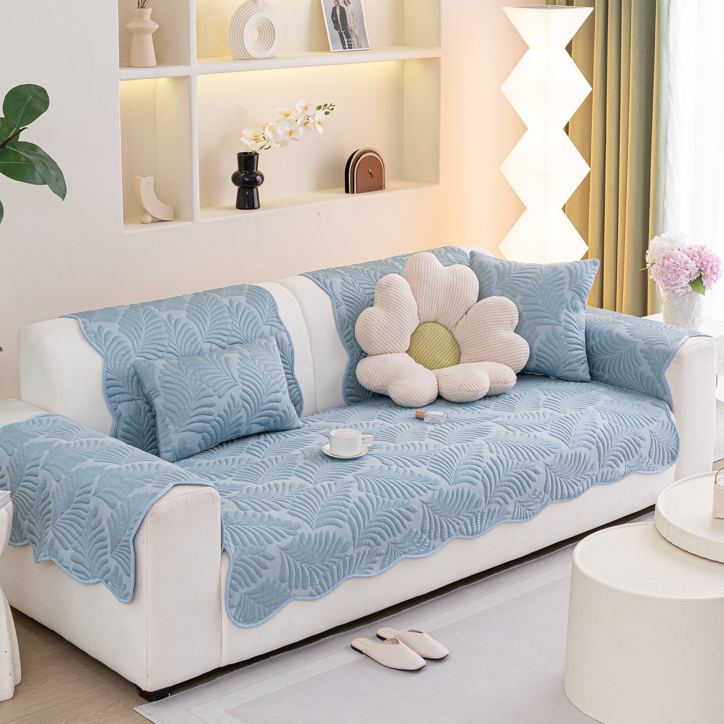 Sofa Cover for Leather & Fabric Couches, 3D Leaf Embossed Quilted Furniture Covers in blue on a white couch in a living room